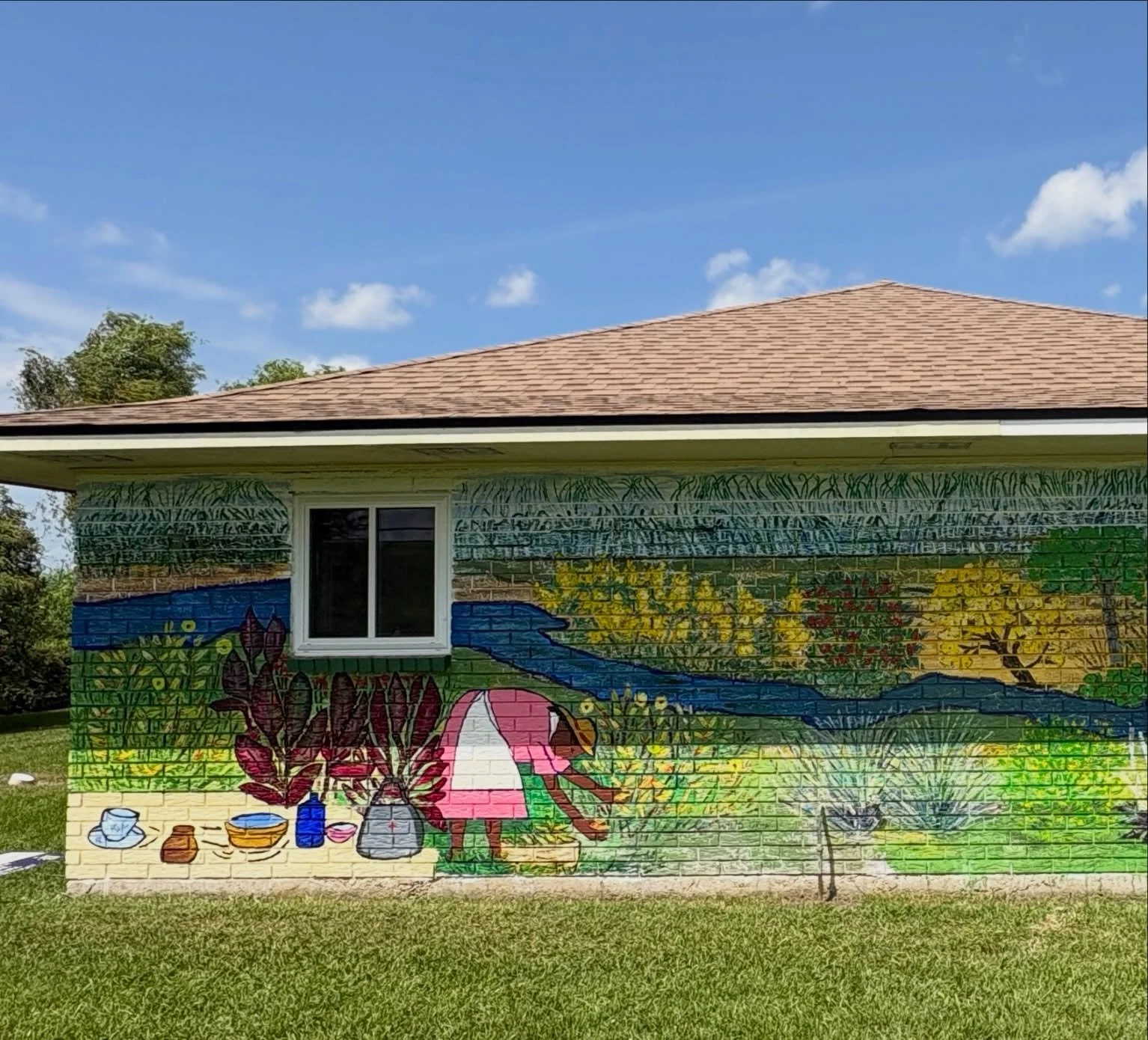 There&rsquo;s a new mural on the River Road in St. James Parish, Louisiana. The colorful art on the exterior walls of The Village Hub in Convent memorializes the underrecognized legacy of the skilled Black midwives of the River Parishes. 

Drawing on
