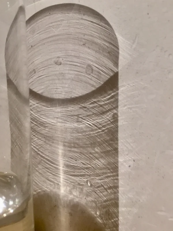 I wake to find that the light has transformed the glass of water on my bedside table.