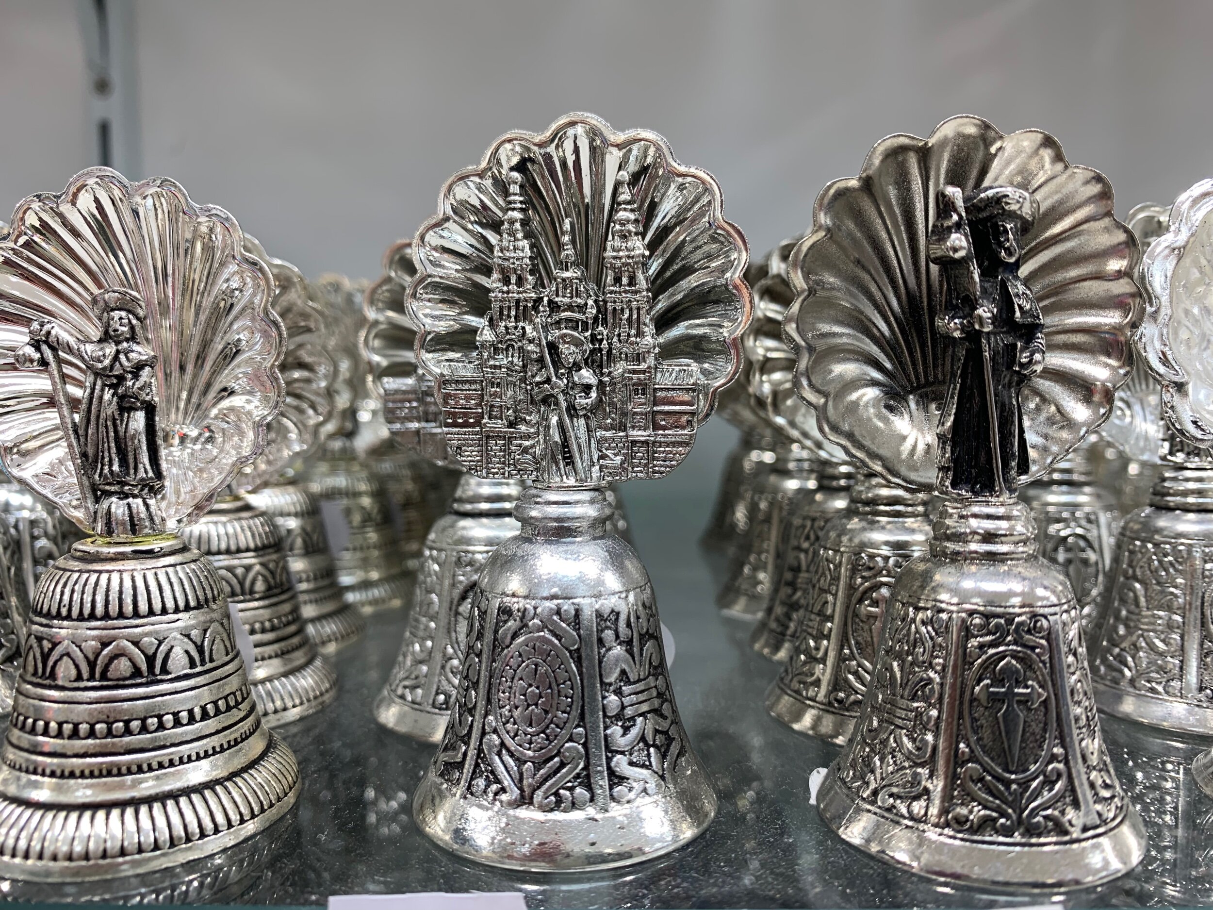 Santiago Old Town is brimming with Pilgrim souvenir shops with an endless variety of apostle bells, badges, holy water stoops. What a friend calls ‘Holy Hardware’. Love it!