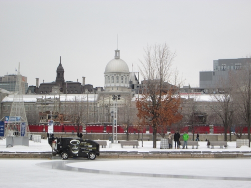 The Zamboni grooms the ice, with the bonsesours market in the background.