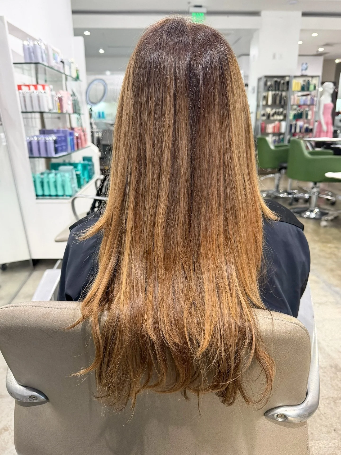 Our colorists took this hair on a full correction journey: toning down the orange, evening out the ombr&eacute;, and adding dimension that looks intentional, not accidental. the result? a rich, sun-kissed balayage that actually looks like you were bo