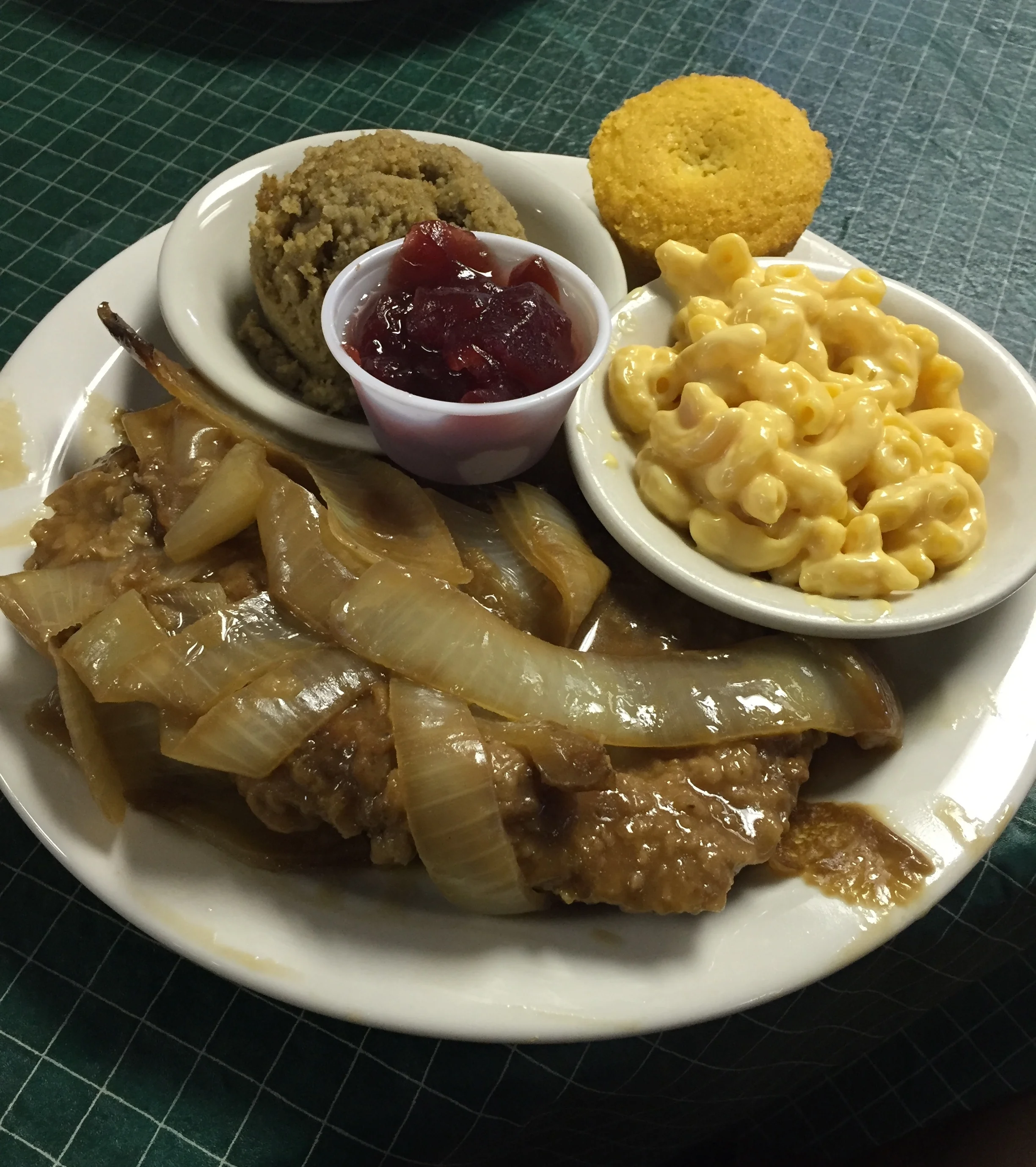 Smothered porkchops with Macaroni and Cheese and cornbread dressing