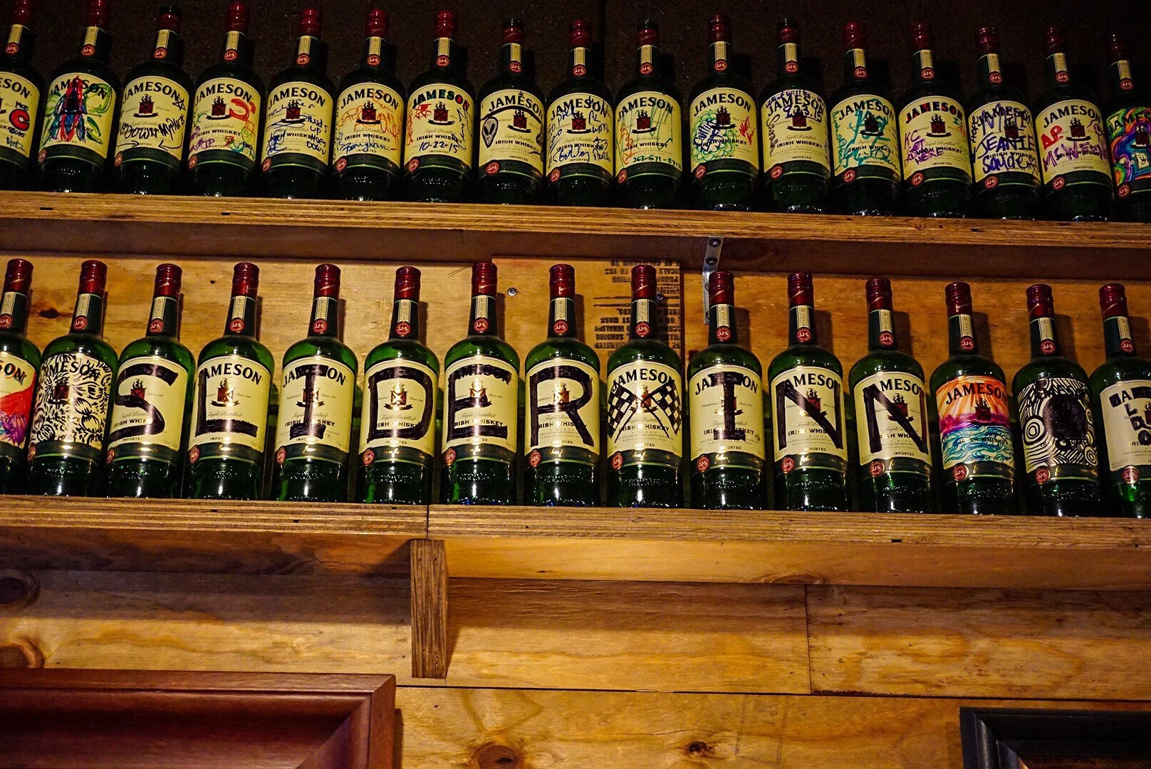 The inside is lined with empty Jameson bottles