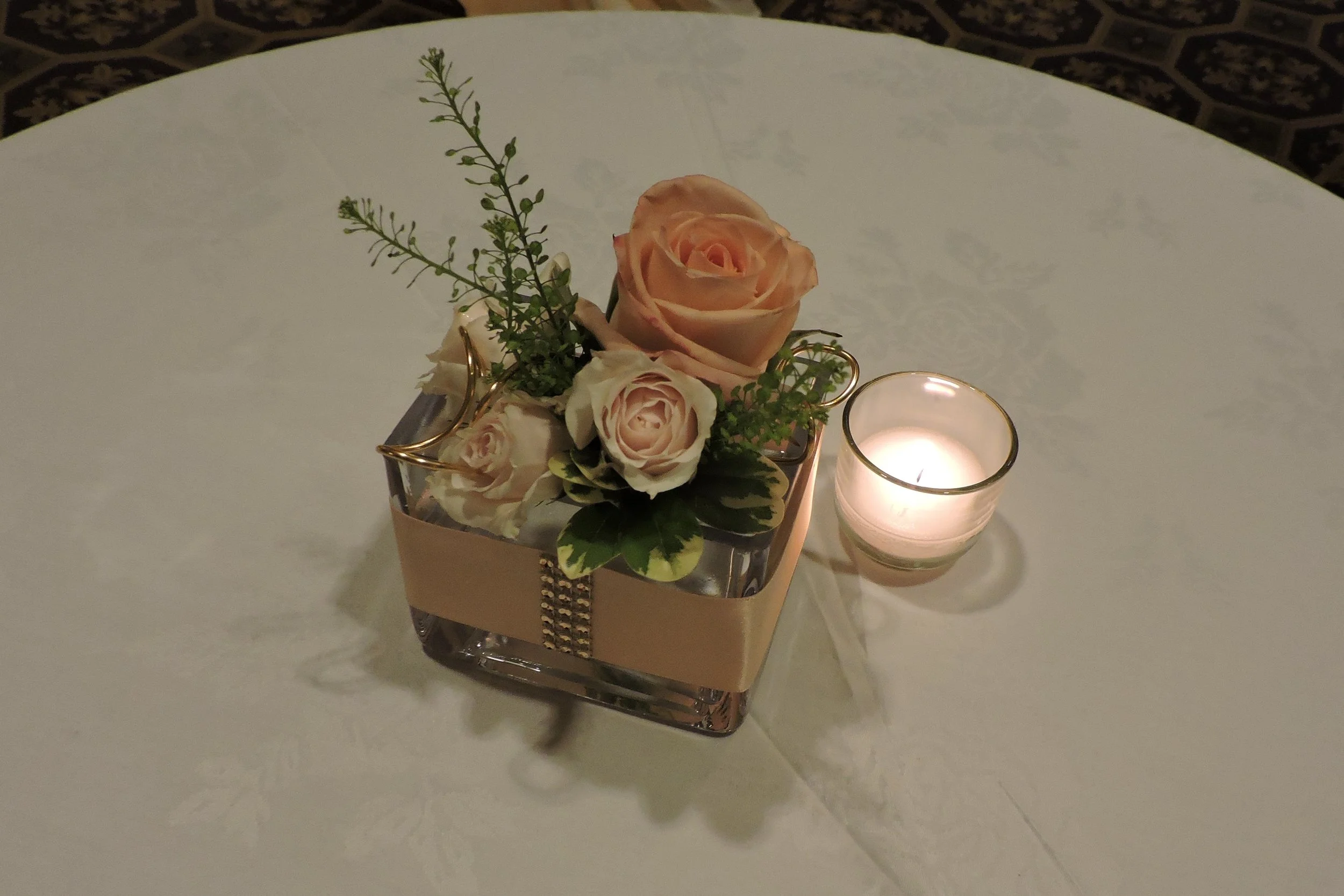 Petite clutch of flowers in embellished glass adorns cocktail table at the Omni Parker House.