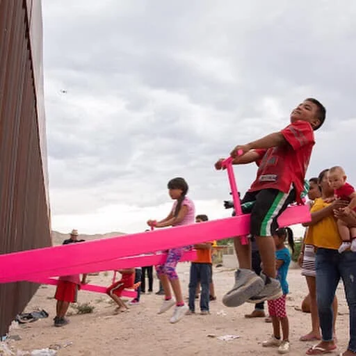 Architects install see-saws along border wall so kids can play together