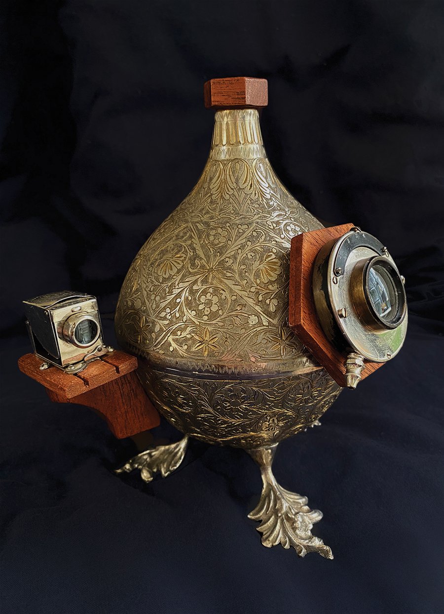 The Duck Foot Camera. One of his most popular creations, it’s made from a nickel-plated music box found in the bazaar. The container flips open to hold sheet film for a single shot.