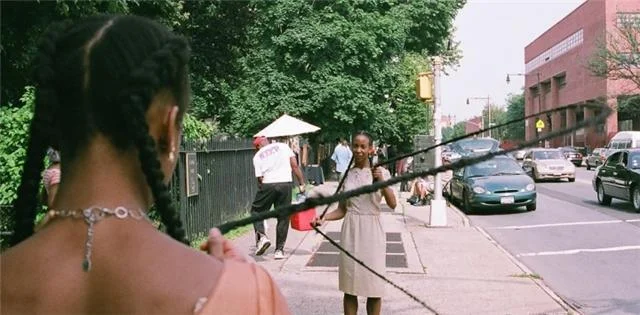 In the double version of Diva Dutch, two black women are connected to each other by their braids to form a living double dutch rope, which passersby are invited to jump into.A performance at BedStuy’s Corridor Gallery is featured in this photo essay from NY’s Daily News