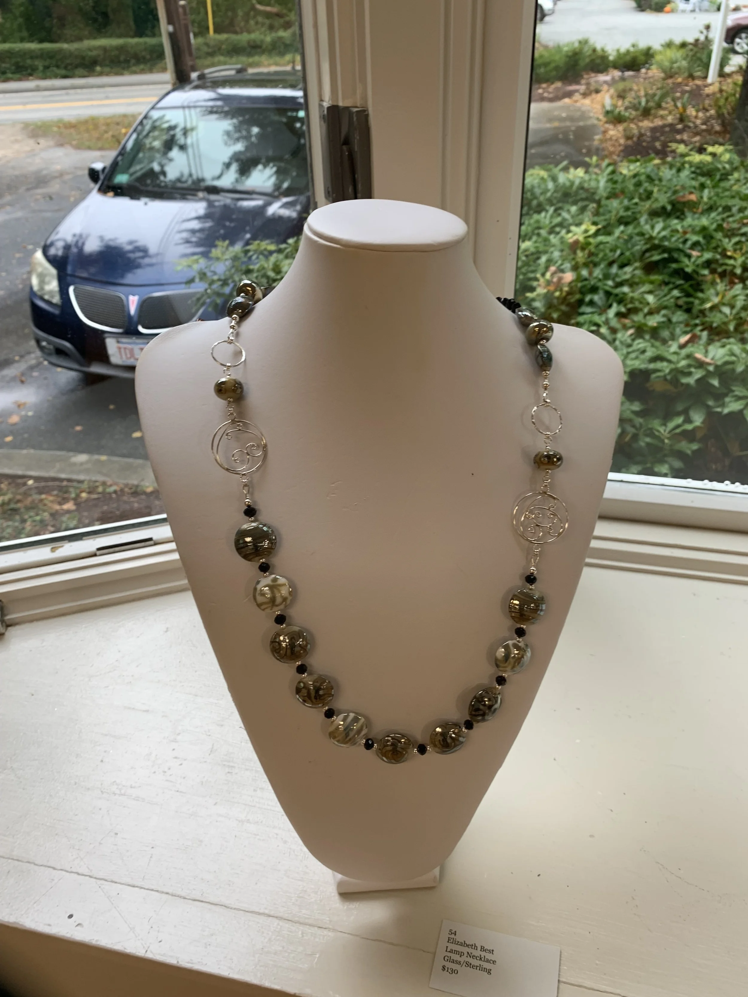 Elizabeth	Best-	Lamp Necklace	Glass/Sterling,	 $130 