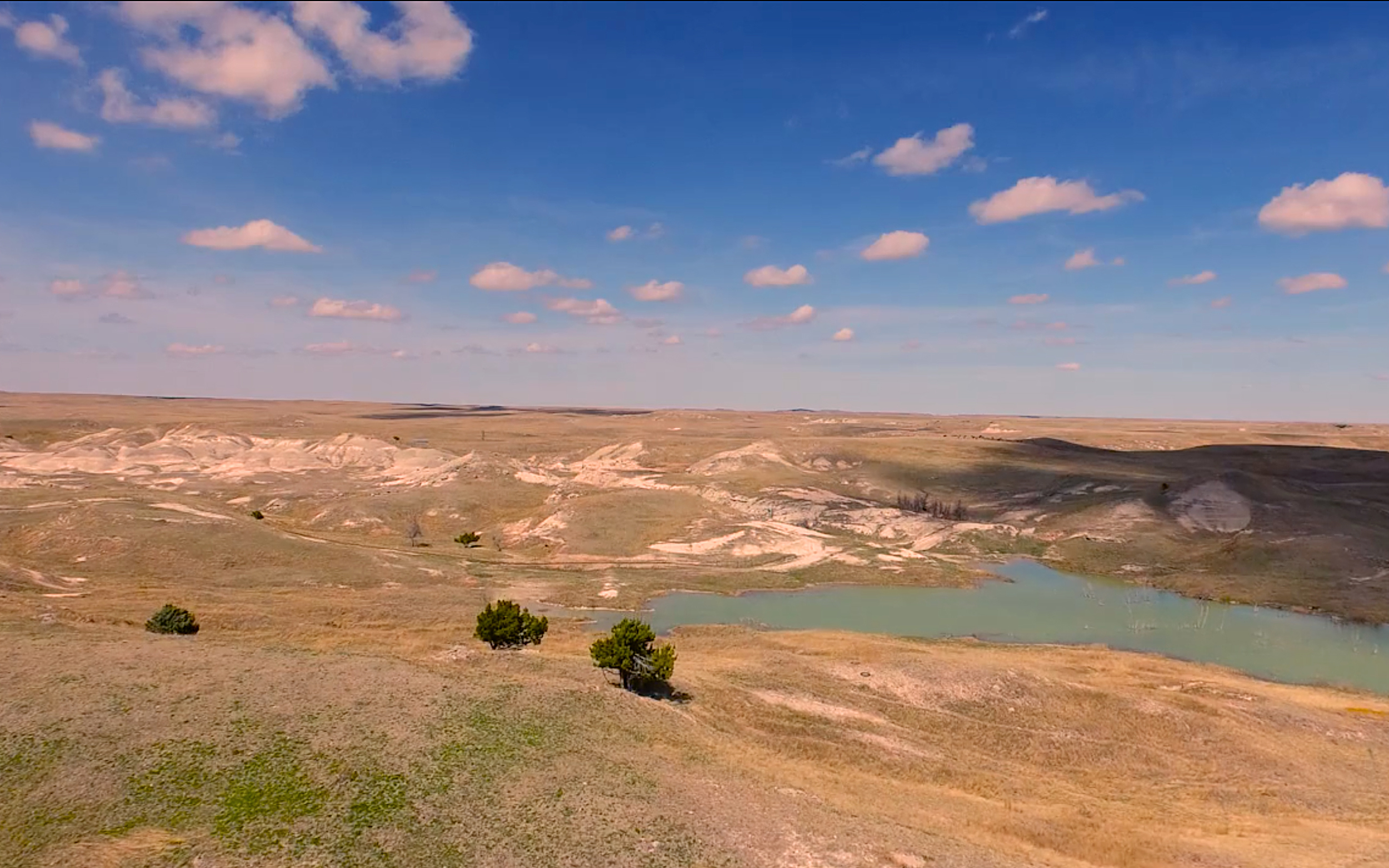 The 777 Bison Ranch pond and surrounding prairie