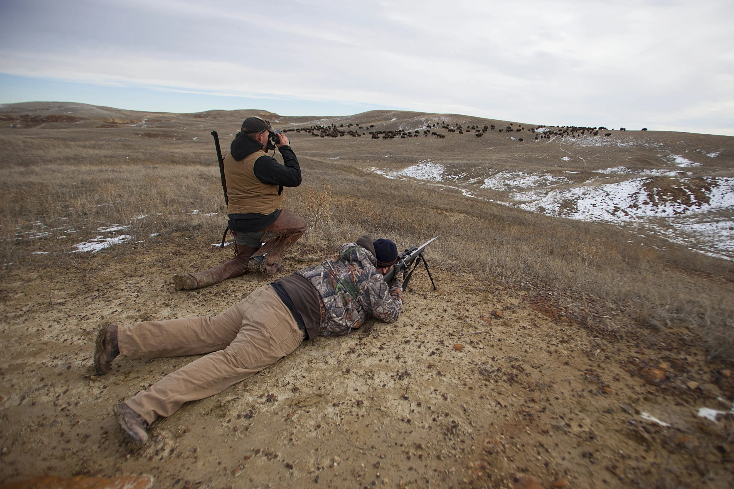 Ranch Foreman, Justin Selke, left, guides a hunter at the 777 Bison Ranch