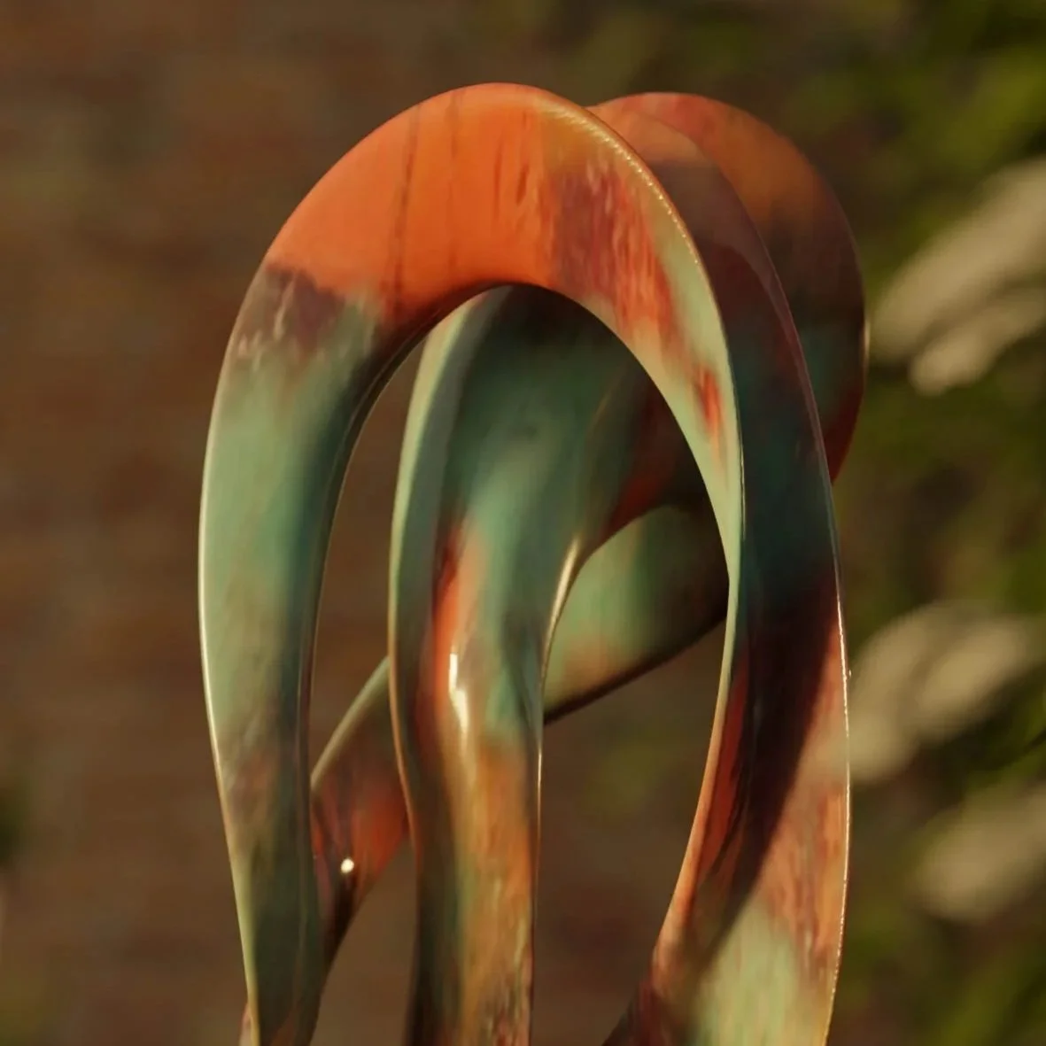 An abstract sculpture made of multicolored, curved, marble-like material, placed on a black pedestal outdoors.