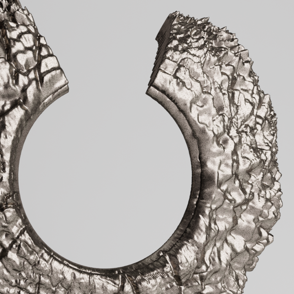 Contemporary sculpture resembling a textured ring or circular form on a rectangular base.