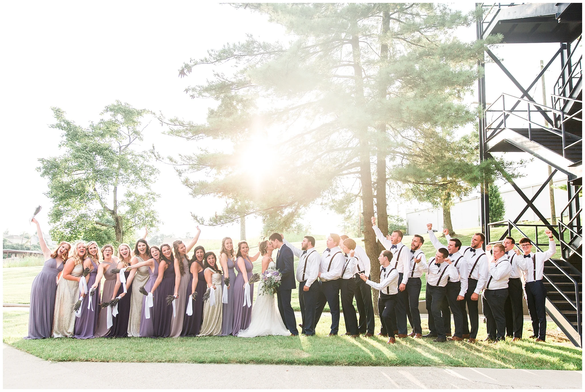 August 10th, 2018 was predicted to be a rainy, hot day but the weather couldn't have been more perfect for the Hughes special day. The bridesmaids woke up in their matching lemon shorts and sparkly gold tops ready to get the day started. Hayden and Marlee, having known each other for almost 4 years, were reminiscing on going from friends, finances, to husband and wife in just 8 short months. The ceremony venue was decked out with 26 people in the bridal party! The bridesmaids wore shades of purple from Lulus and the men wore navy suits and bowties. Hayden's tie complimented the theme with a purple floral pattern. Marlee wore a dress from the Steel Magnolia that was form fitting, lace, and had tons of pearls and sparkles. Each bridesmaid carried a bouquet of dried lavender, the smell was amazing! The reception had beautiful, tall orchids from Rainbeau Orchids and gold sparkles incorporated everywhere. Drinks and desserts were offered and the dancing was definitely a requirement. As Hayden and Marlee said goodbye to their friends and ran under the sparklers, Hayden's dad mistakenly followed, such a funny ending to an even funner wedding. This wedding also has a very special place in my heart because it was my very first wedding that was published in a magazine, it was published in Bridal Bliss Magazine.