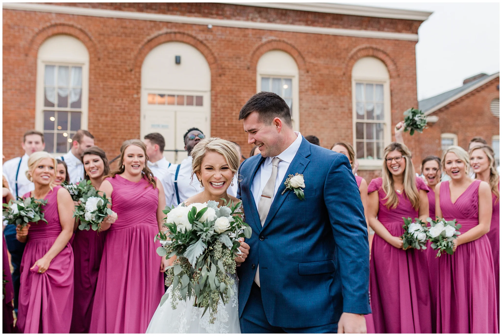 Danielle and Hunter's winter wedding day was filled with their love for Christ and the spirit of Christmas. Danielle and her 14, yes 14, bridesmaids started the day at a huge, beautiful house in downtown Cincinnati. The amazing wood embellishments in the house popped in the background against the matching flannel bridesmaid pajamas. The groomsmen got ready at an AirBNB in Over the Rhine and it was equally as stunning. The ceremony was held at Christ Church United which was decked out in Christmas decor and had a huge vaulted ceiling. Danielle and Hunter said, "I do" standing next to a huge christmas tree surrounded by a packed out sanctuary of people. The reception venue was so unique, The Mess Hall at Fort Thomas has been renovated to hold large weddings and facilitate the perfect wedding night. The wedding details were captured by an amazing team. Hunter Rogers was the wedding coordinator and did such an amazing job, she inspired Danielle to pursue doing the same thing to help other brides! The video was captured by Morgan Price who always catches the sweetest, tear-jerking moments and I was lucky enough to take these wedding photos for Danielle and Hunter who are so near and dear to my heart!