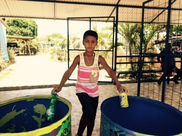 A student putting his recycling knowledge to the test.