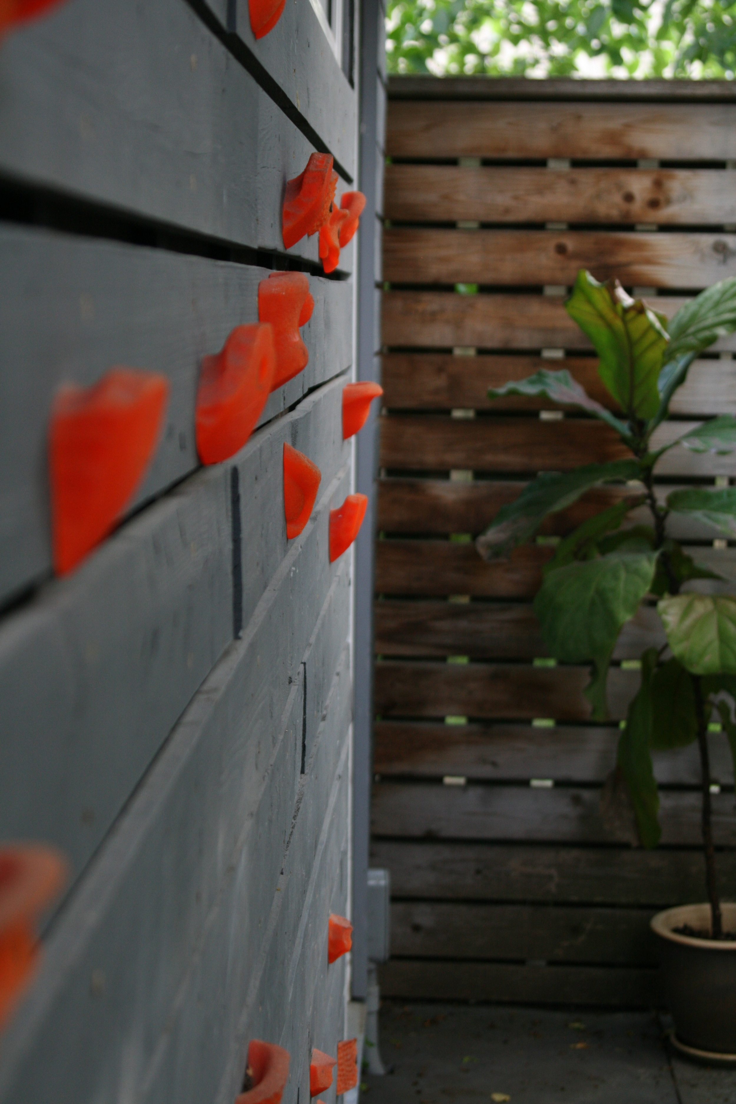 Garage wall re-clad with old fence boards.