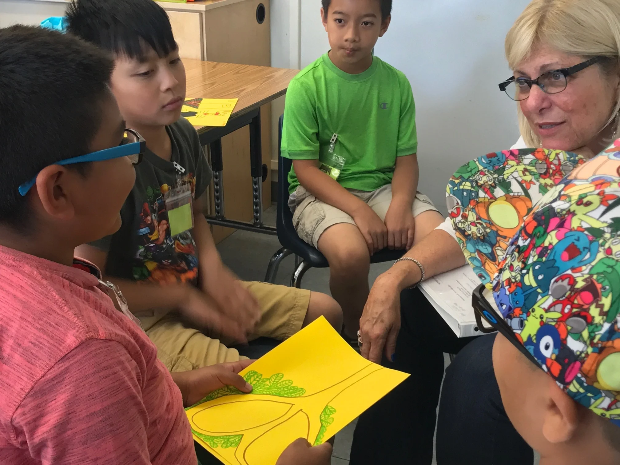 One of the volunteers in the Readers in the Heights program sits with students as they discuss the reading.