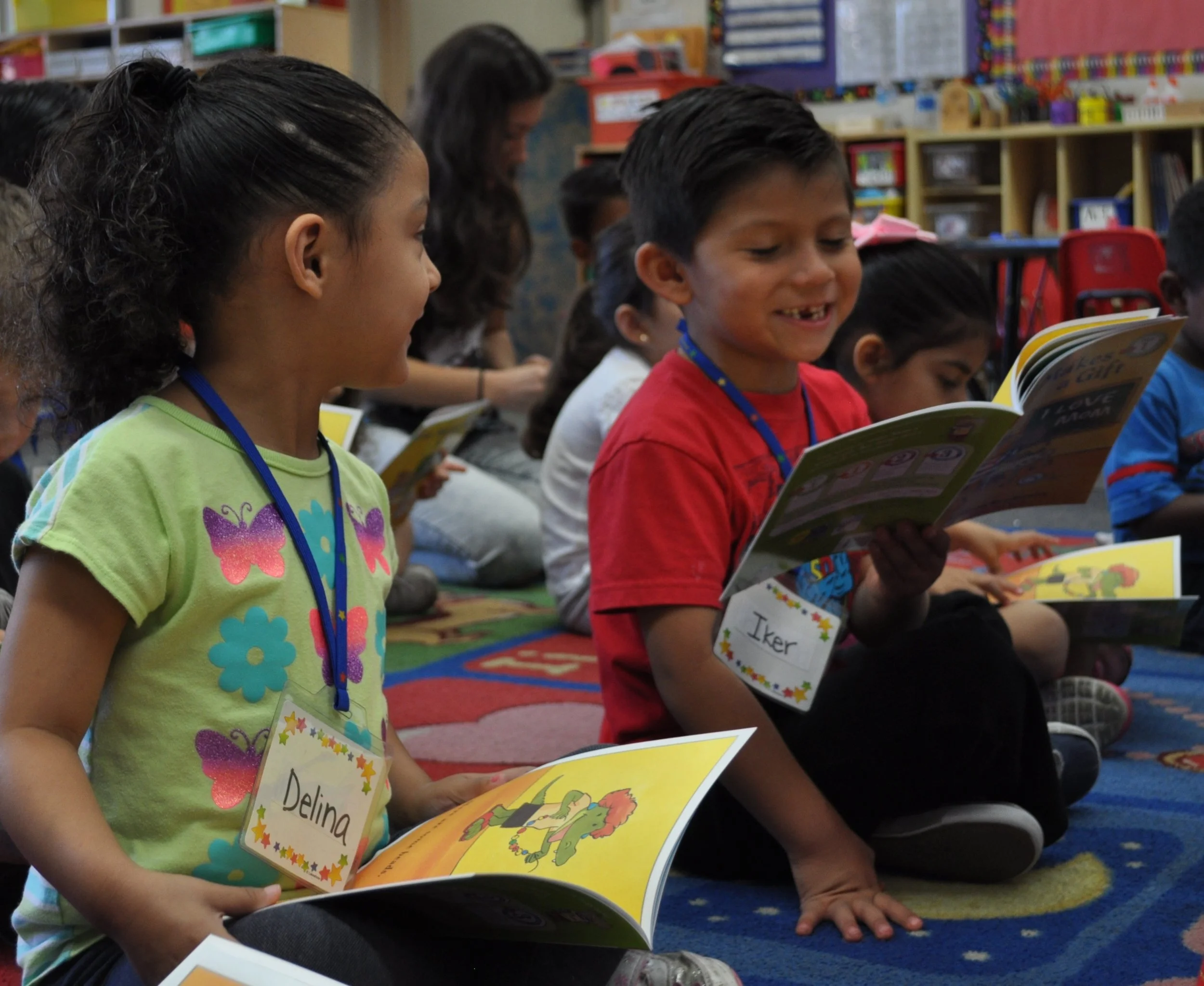 A picture of two elementary school students in our Read Aloud Program exploring a book together!