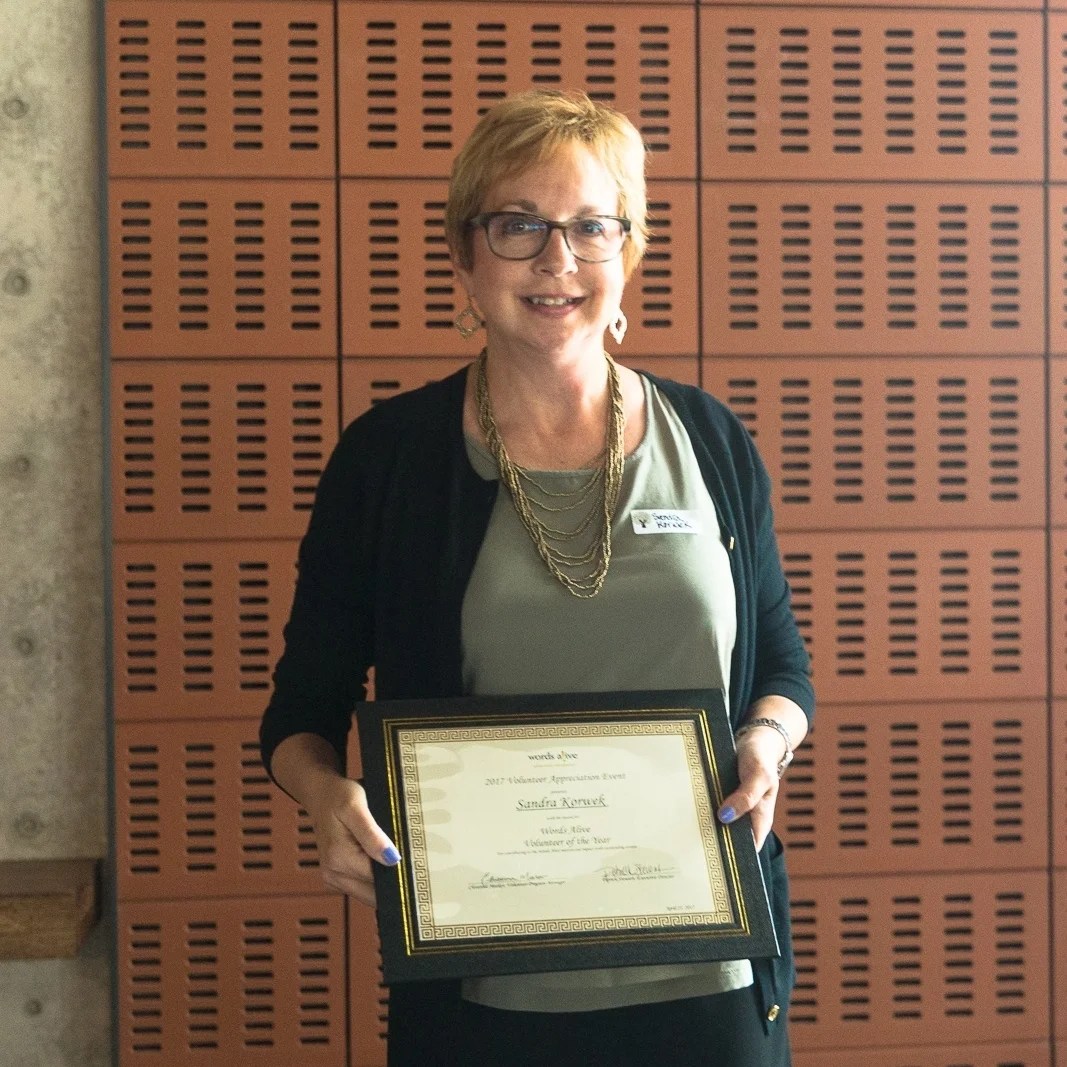 A picture of Sandra Korweck holding her Volunteer of the Year Award at our 2017 Volunteer Appreciation Event.
