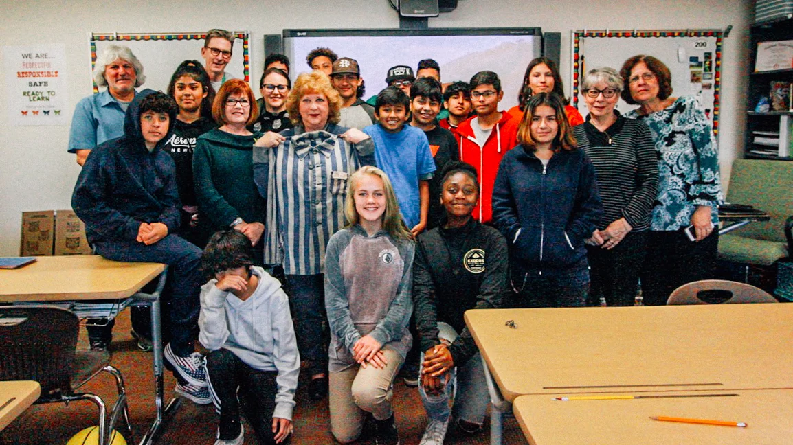 A group picture of The Butterfly Project presenters with Stephen Keiley's 8th grade class at Monarch School and Words Alive ABG volunteers.