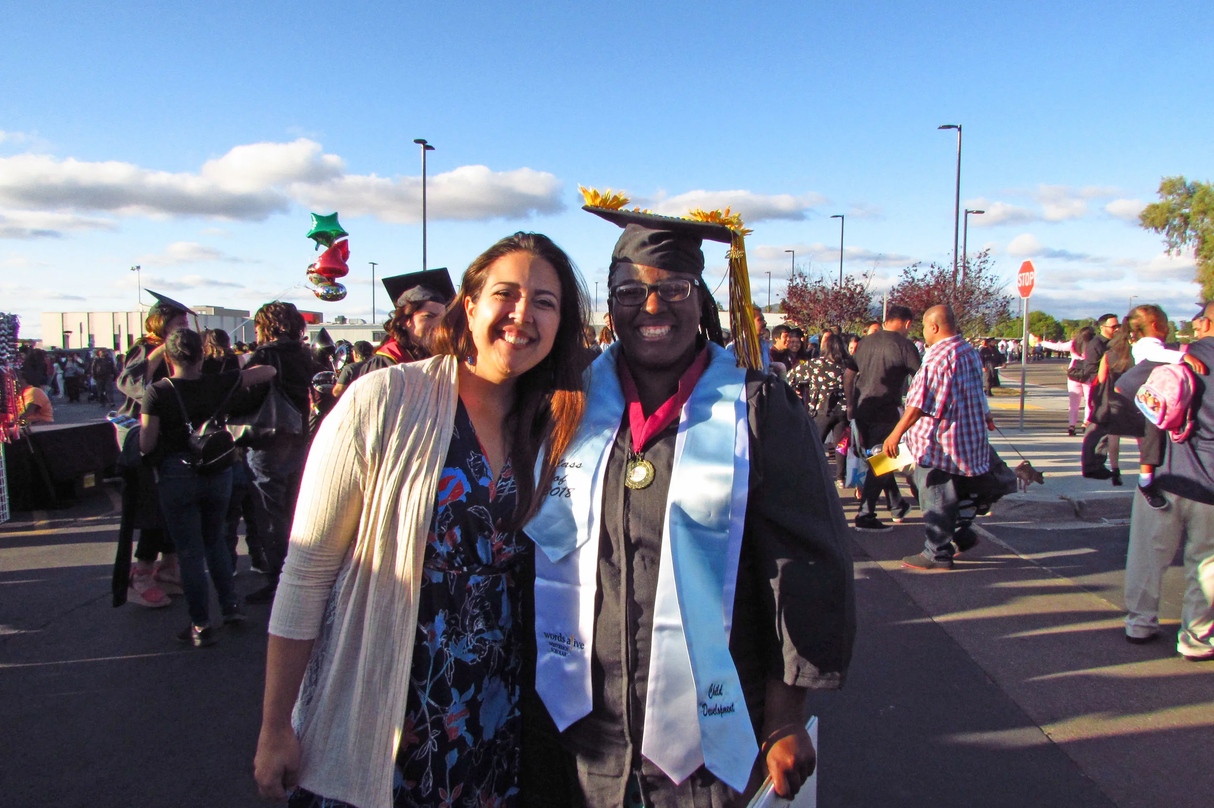 An image of Jessica Fryman, Teen Services Program Manager, and Domminice Willis at the graduation!