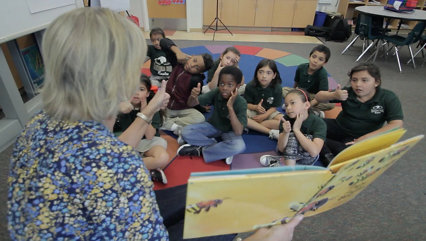 An image of one of our Read Aloud Program volunteers reading to a classroom at Golden Hill School.