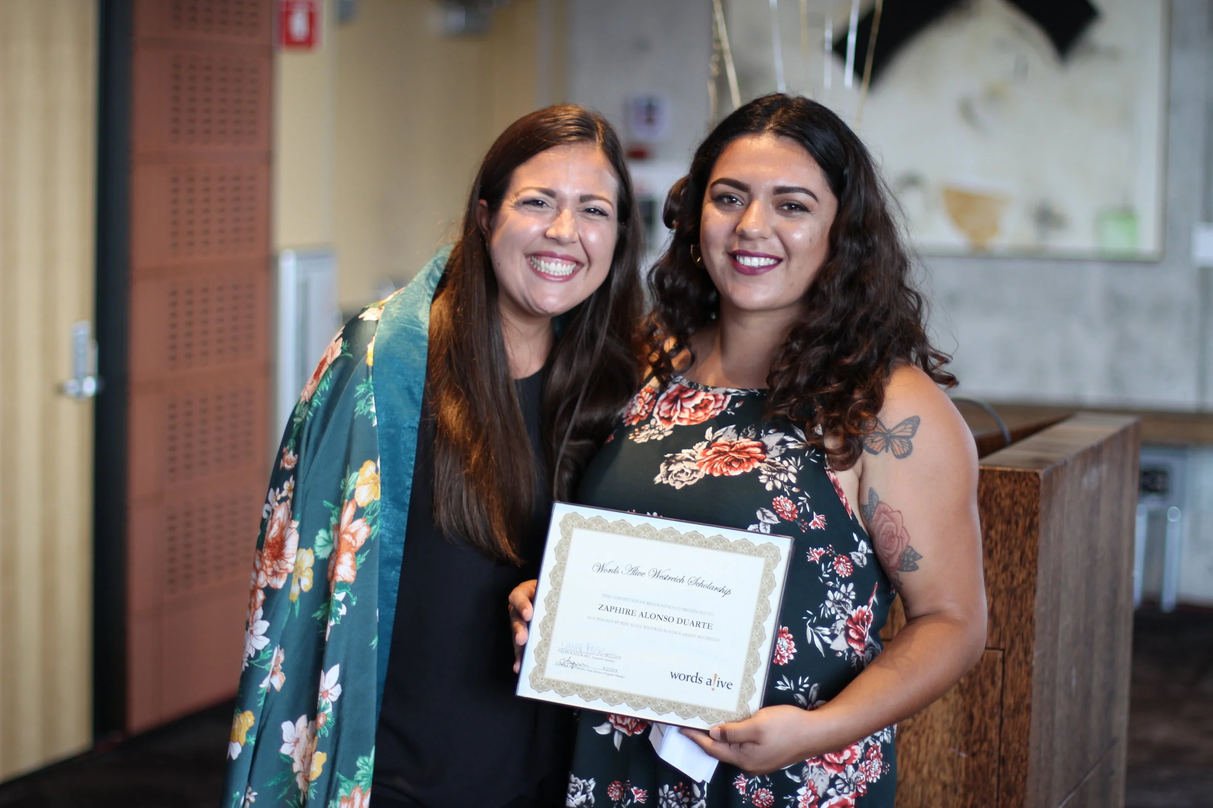 An image of Jessica Fryman, Teen Services Program Manager, standing with Zaphire at the Words Alive Westreich Scholarship Ceremony.