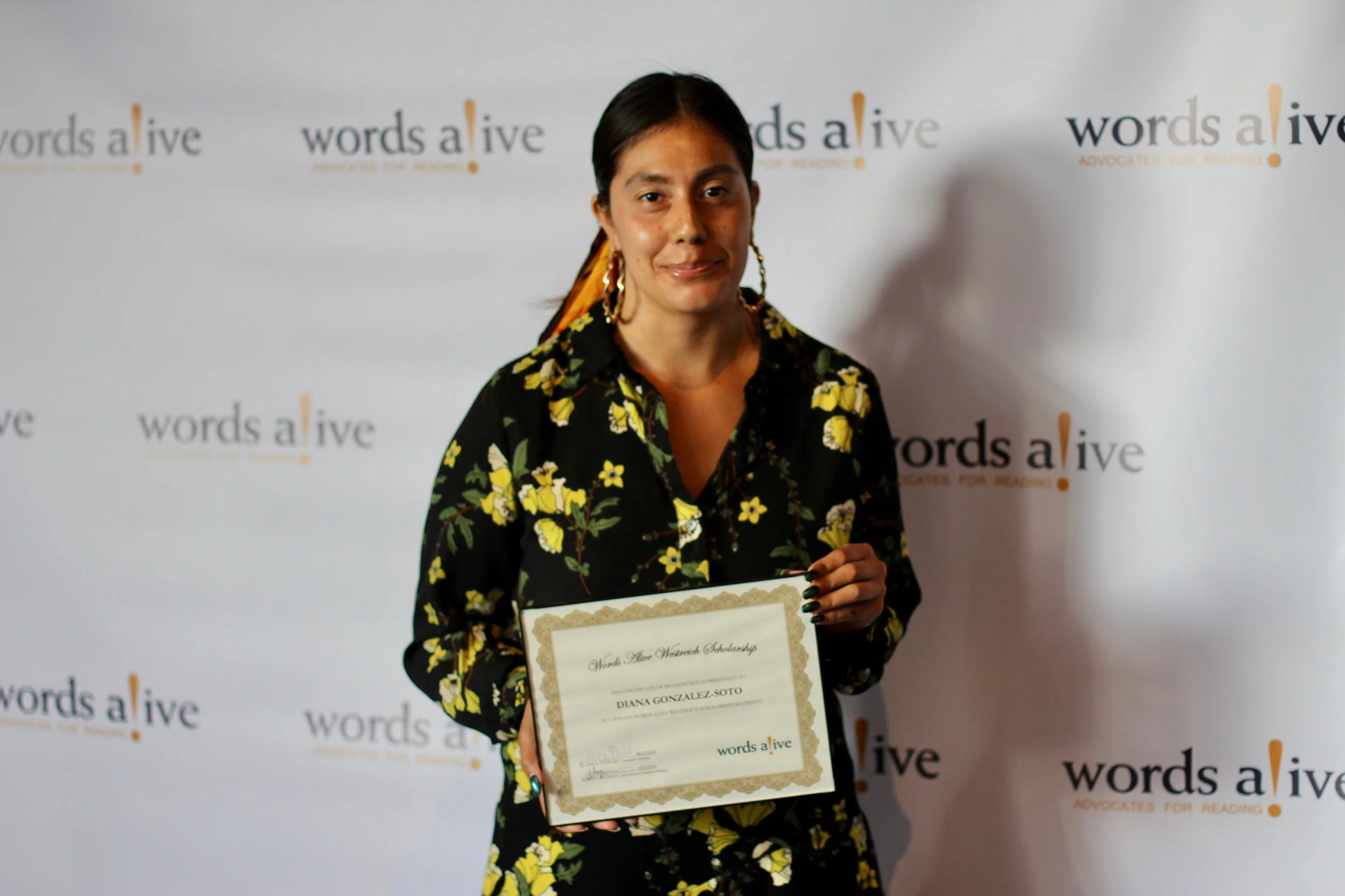 An image of Diana holding her award at the Words Alive Westreich Scholarship Ceremony.