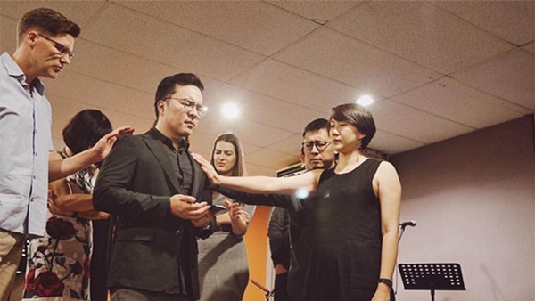 The current PenHOP leaders praying over Josh Yeoh during the 8th Year Anniversary.