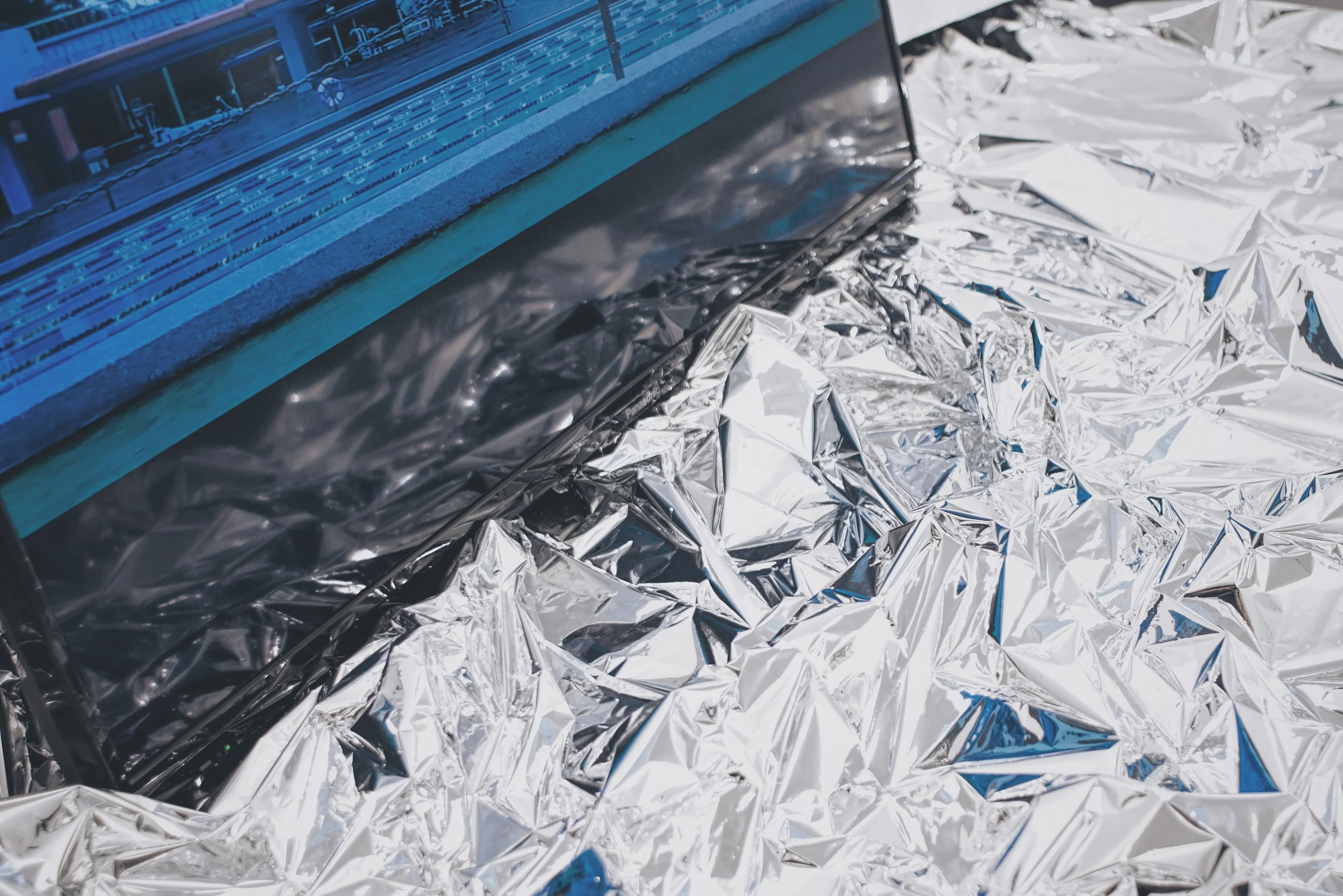  Youth Water Paradise Horizon Emergency (detail) video (0:55), tv, emergency blanket, 52" x 84" x 19" 