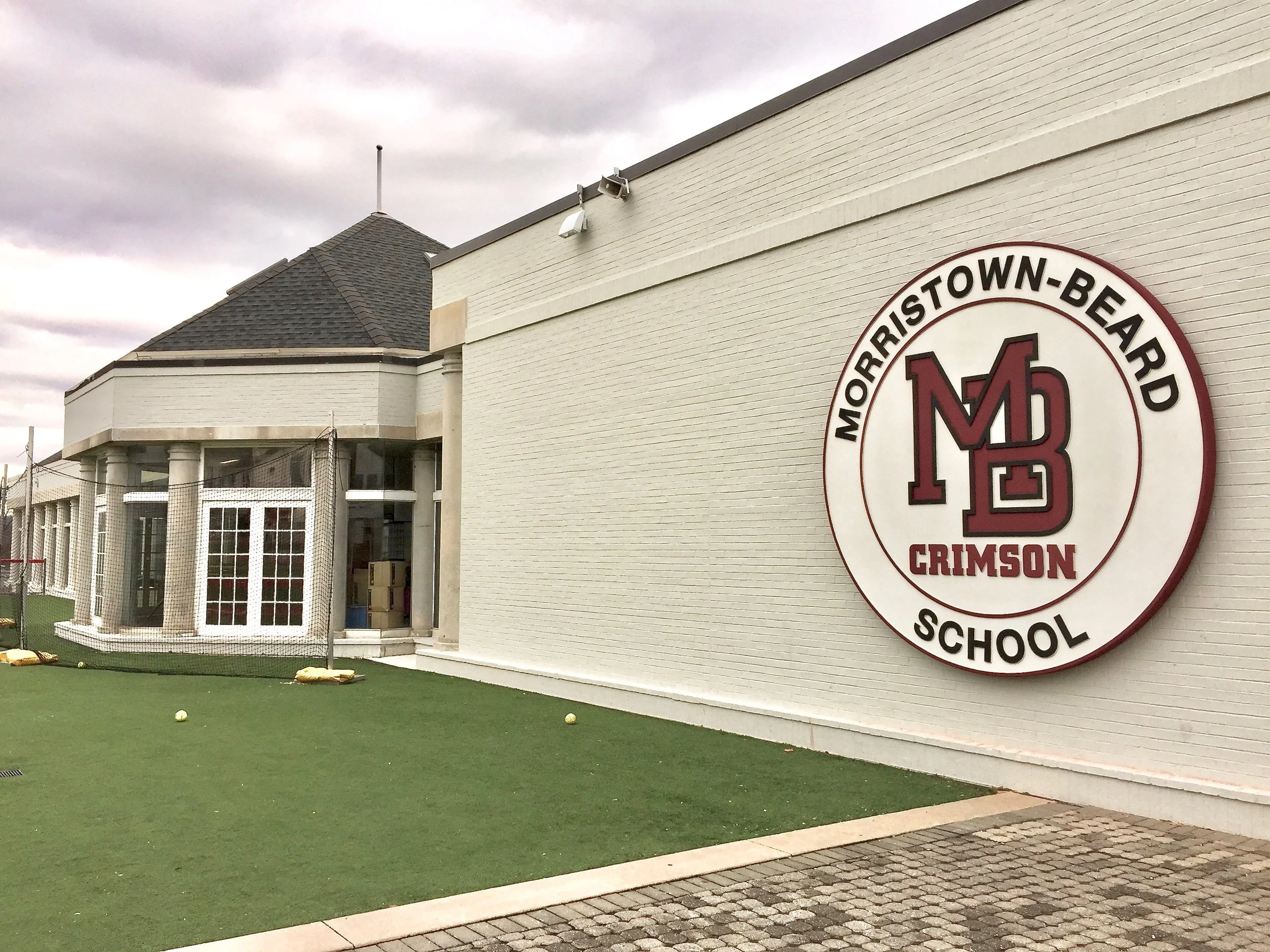 We were commissioned by Morristown-Beard School, a private school in Morristown, NJ to to carve and install this large scale medallion to face its main building and athletic field. It was carved out of flexible foam and given a flexible hardcoat with a stucco finish on top making it blend in perfectly with its painted masonry background. The flexible core of this carved sign allow it to take an occasional hit from from a foul ball and bounce back as if nothing happened. Basiically it looks great and can take a punch.