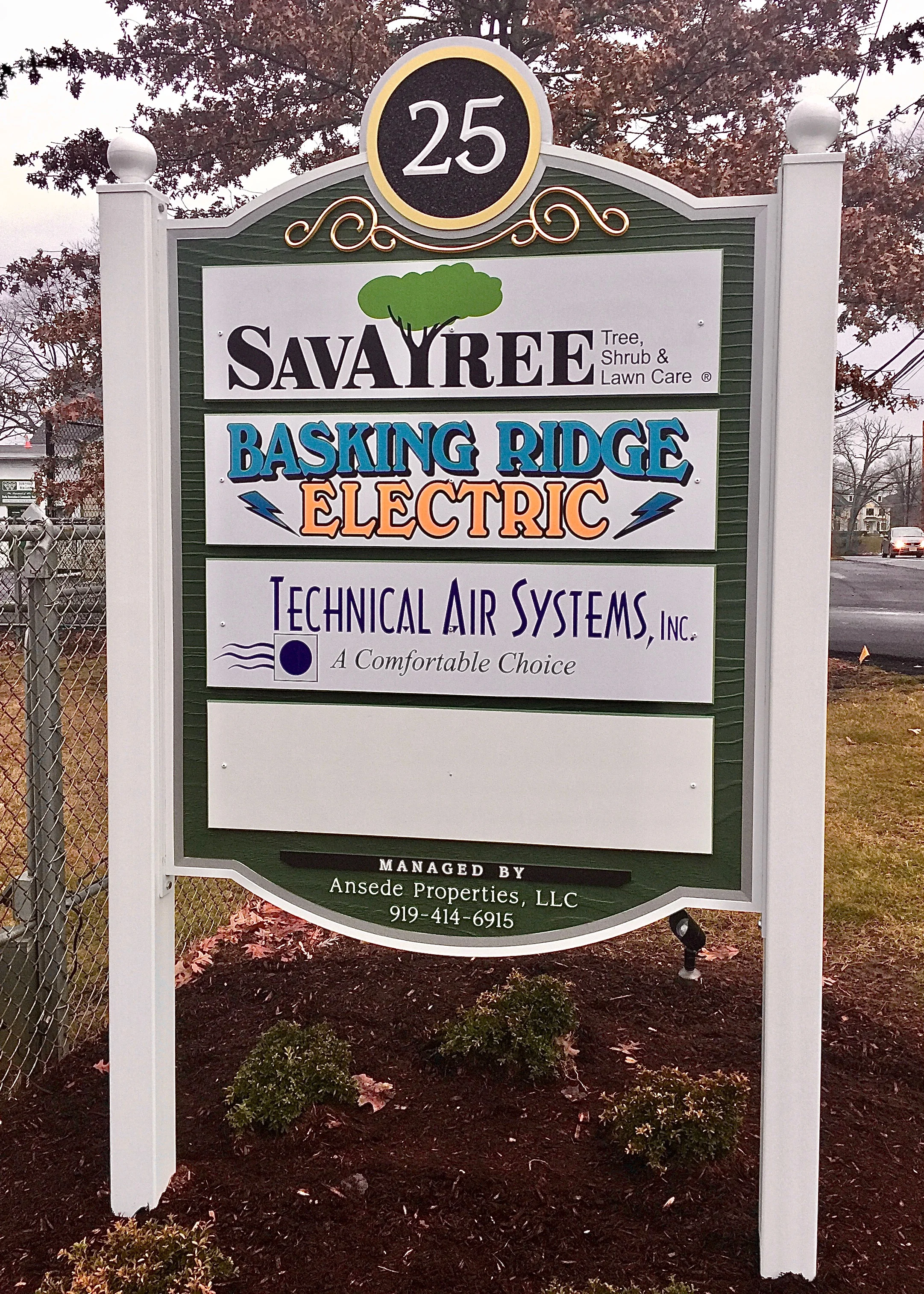 This hand crafted Industrial Park Sign in upscale Basking Ridge is just what this facility needed. This solid PVC sign features a carved woodgrain background giving it the warmth of a wood sign with the weather resistance of PVC. Behind the address is a background of sparkling crushed black glass with a 23K gold leaf prismatic flourish that really sparkles in the sunlight.