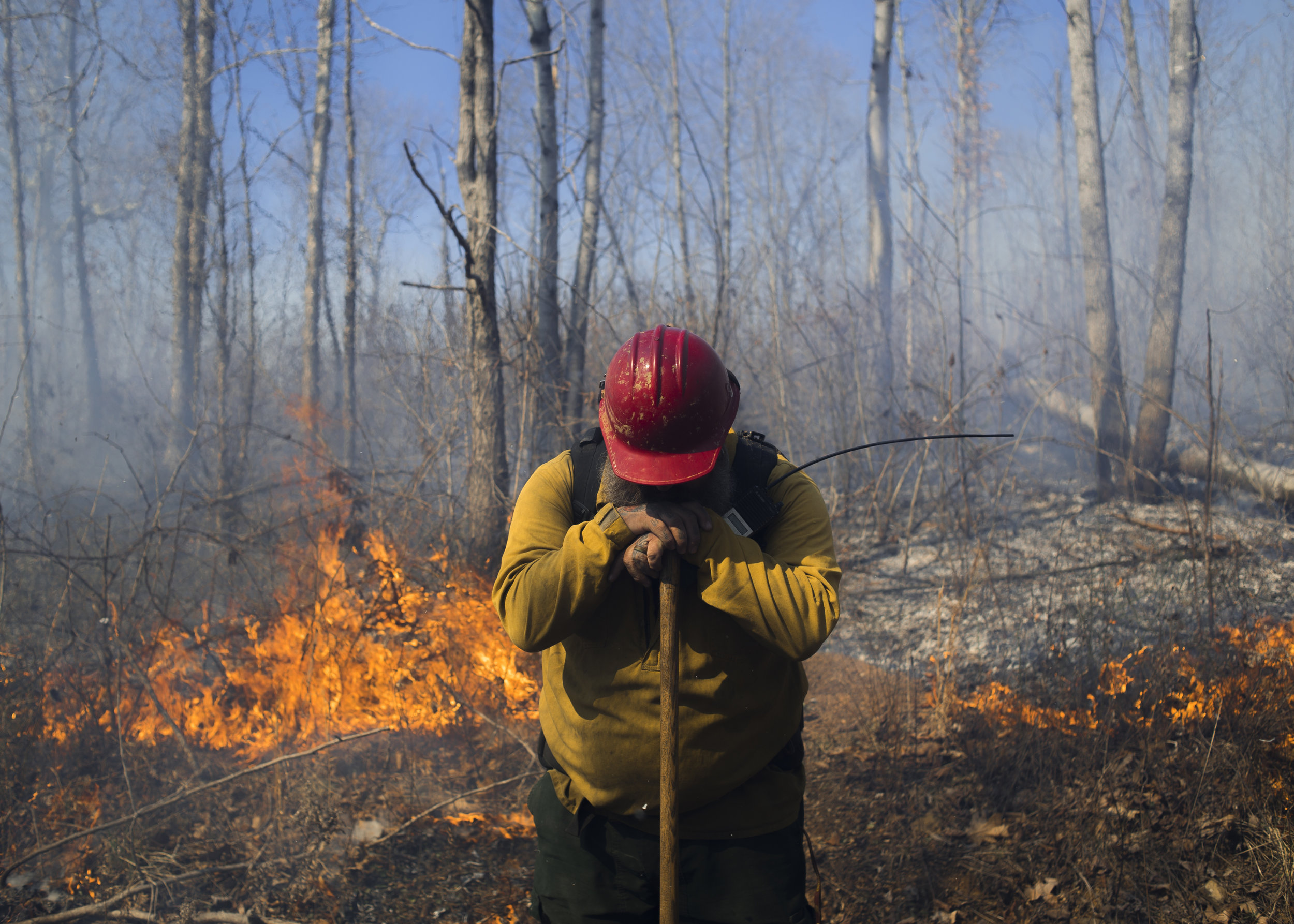  Jason Bew, the engine captain at the Wayne National Forest service, takes a momentary break late in the day of a prescribed burn on Friday, March 17, 2017.  