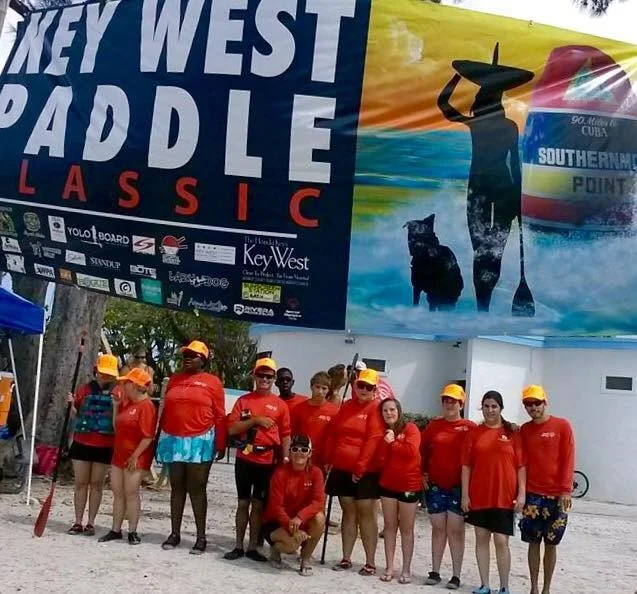 Lazy Dog owner, Sue, pictured with athletes of Key West Paddle Classic.