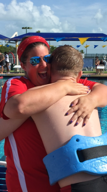 Laurie Skinner hugging a Special Olympics Monroe County swimmer after he competed at the 2017 State Games