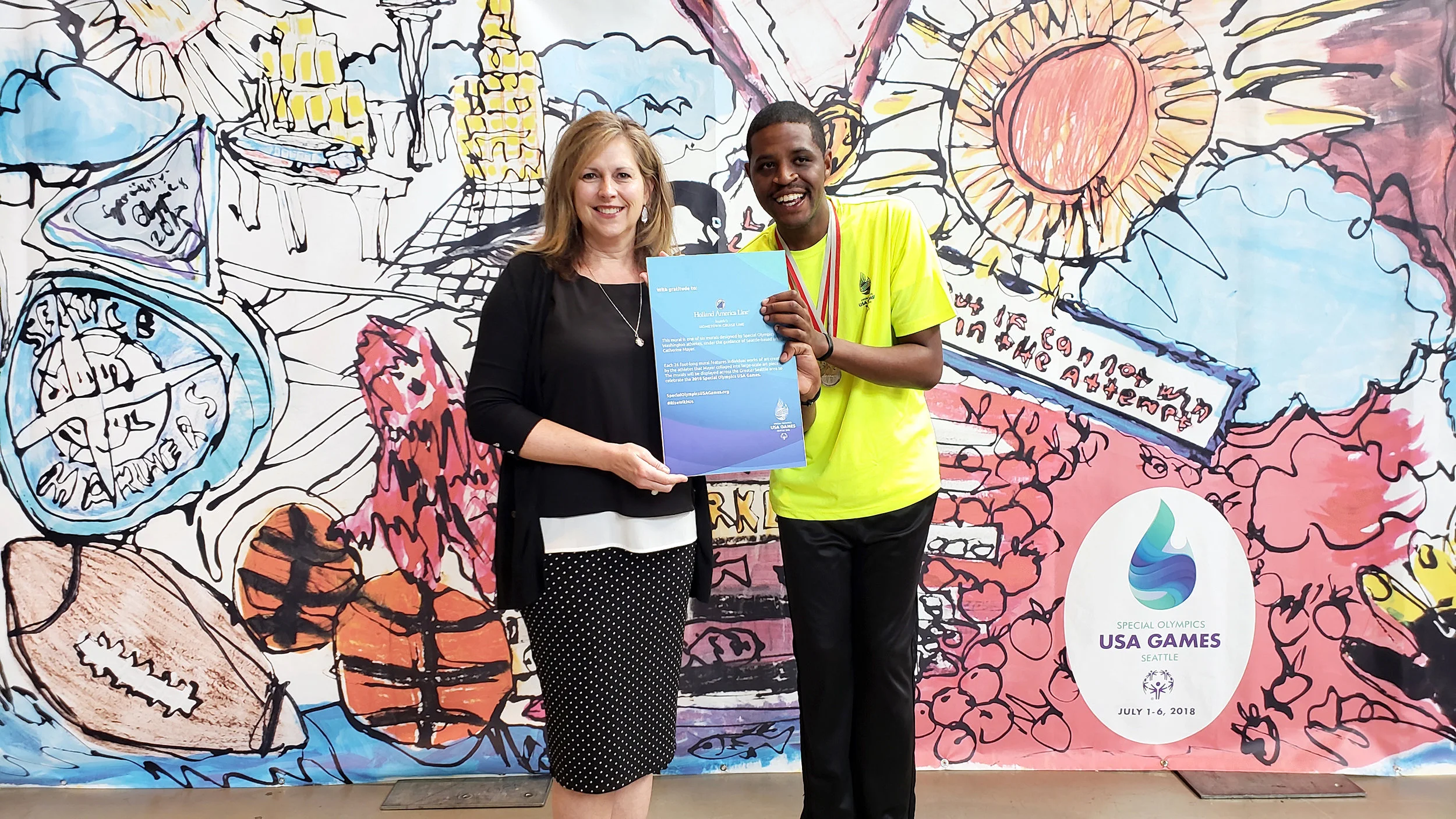 Sally Andrews, VP of Public Relations for Holland America Line and Special Olympics athlete, Frankie Hogan at the unveiling of one of the murals at the Seattle Center Armory.
