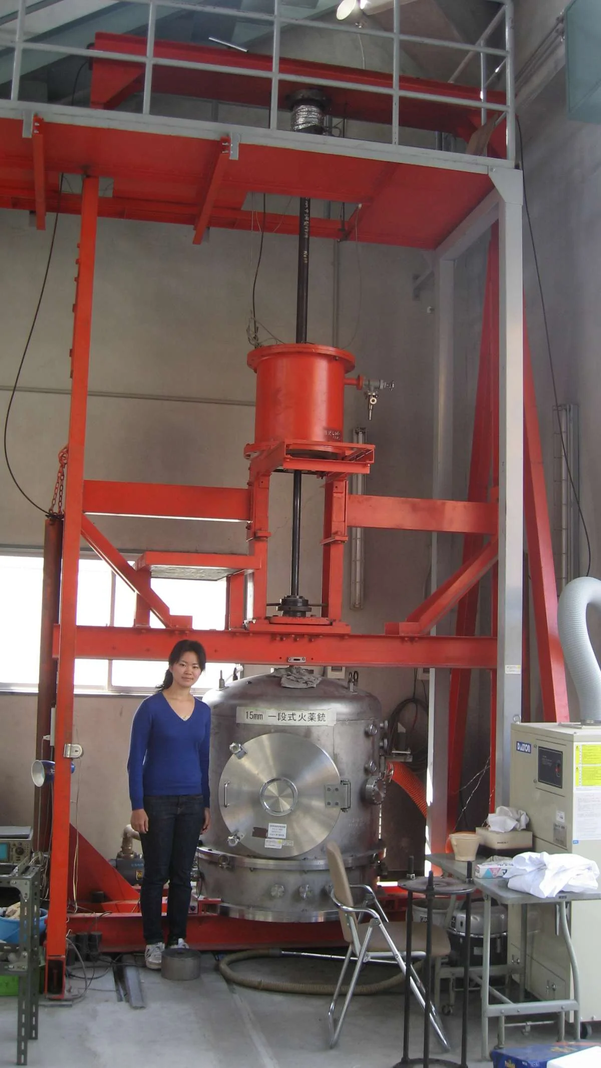 Haruna Sugahara Vertical Propellant Gun Haruna Sugahara, lead author of the study, stands next to a vertical propellant gun.