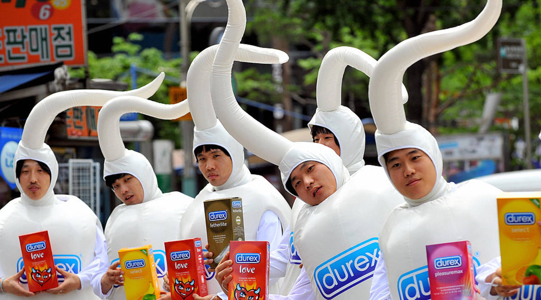 Men working for British condom maker Durex show off samples for a promotional campaign in Seoul on June 24, 2008. - JUNG YEON-JE/AFP/Getty Images