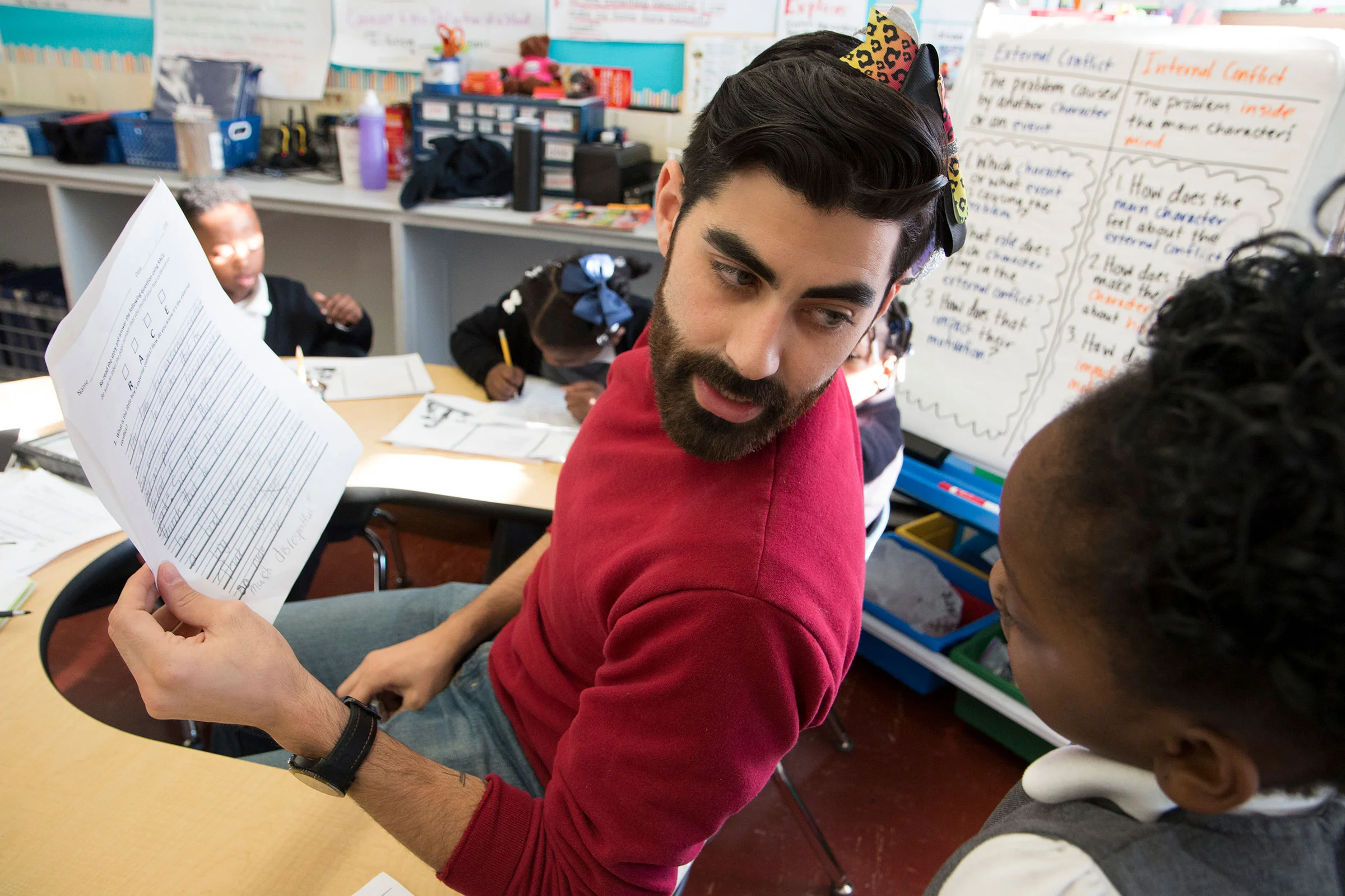 Second grade teacher, Kevin Grijalva, teaches a lesson with a bow in his hair to illustrate the "character trait of the Month:" openmindedness. "It started out as a joke," said Grijalva, "and it's just become a nice way to have these in-the-moment conversations about why to be open minded, why it's important, and how we can treat others with an open mind."