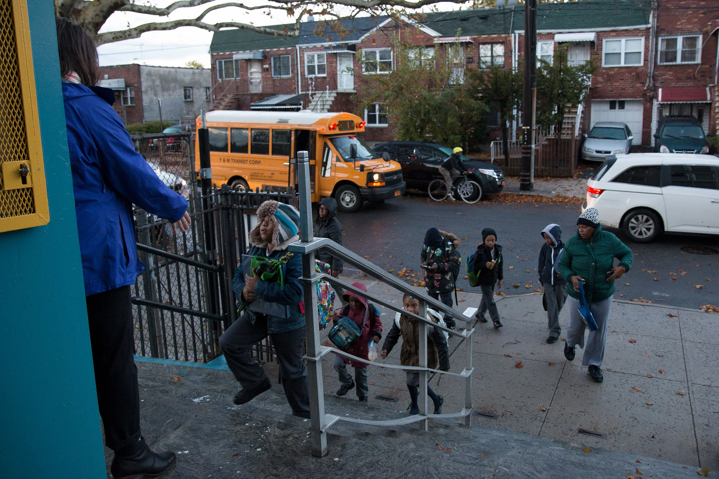 Second grader, Jaydian, enters school in the morning with fellow students.
