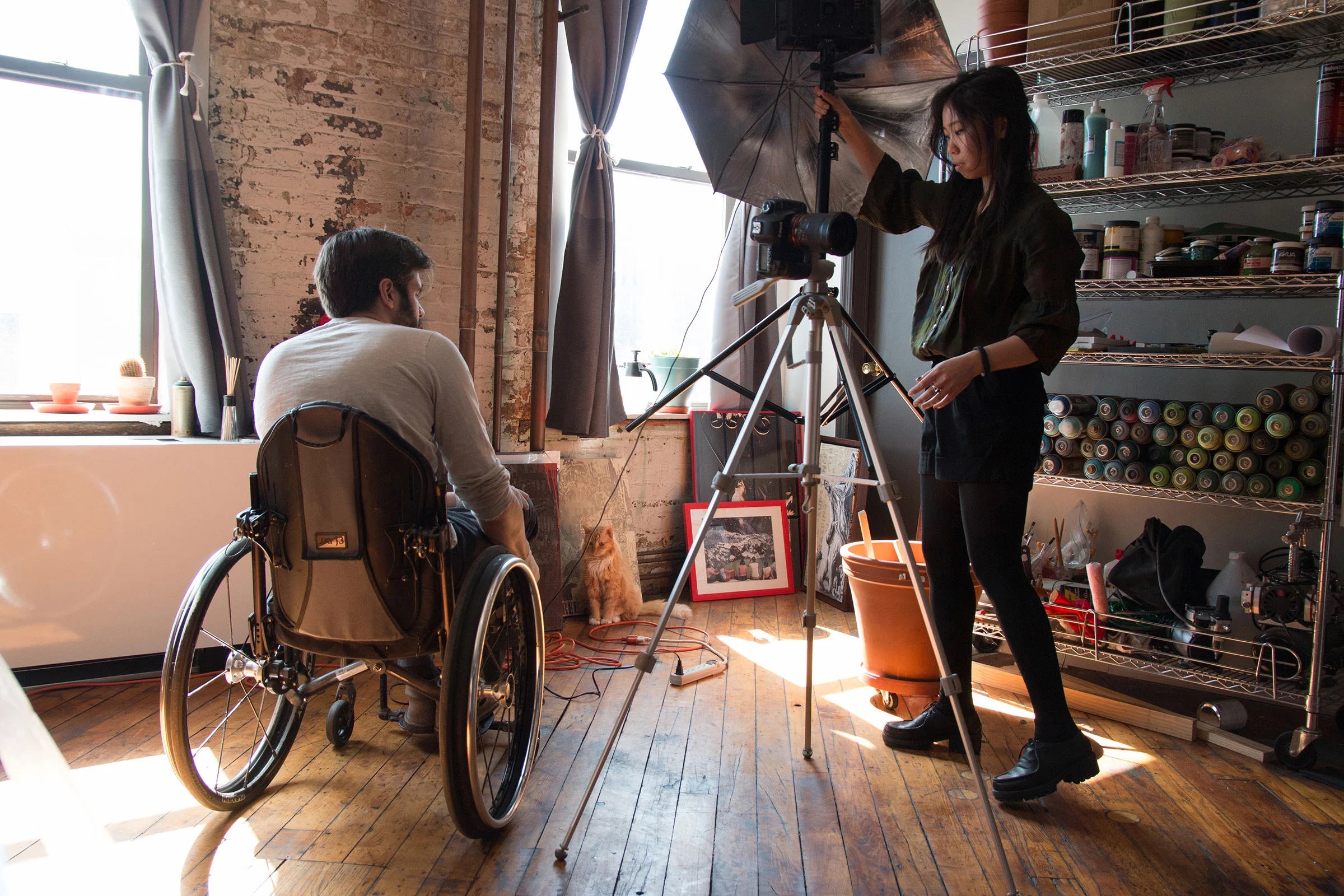 Filmmaker Chloe Lee modeled for many of B.D. White’s stencils and paintings. She helps White take photographs of the work at his studio.