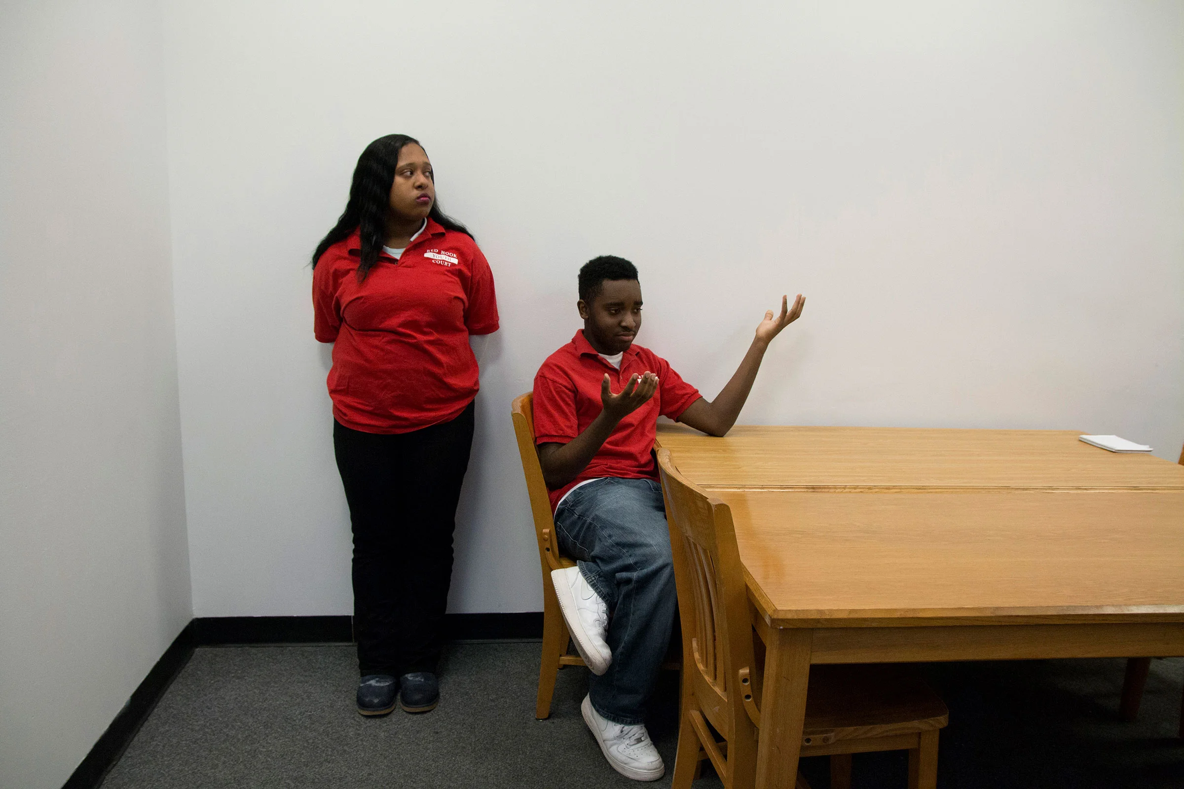  Shawna, 18, (left) and Louric, 15, (right) deliberate with other teens from the jury to decide on the sanctions for a case of truancy, or skipping school. “One thing I’ve learned from being here is the exploration of altercation,” said Louric, “basi