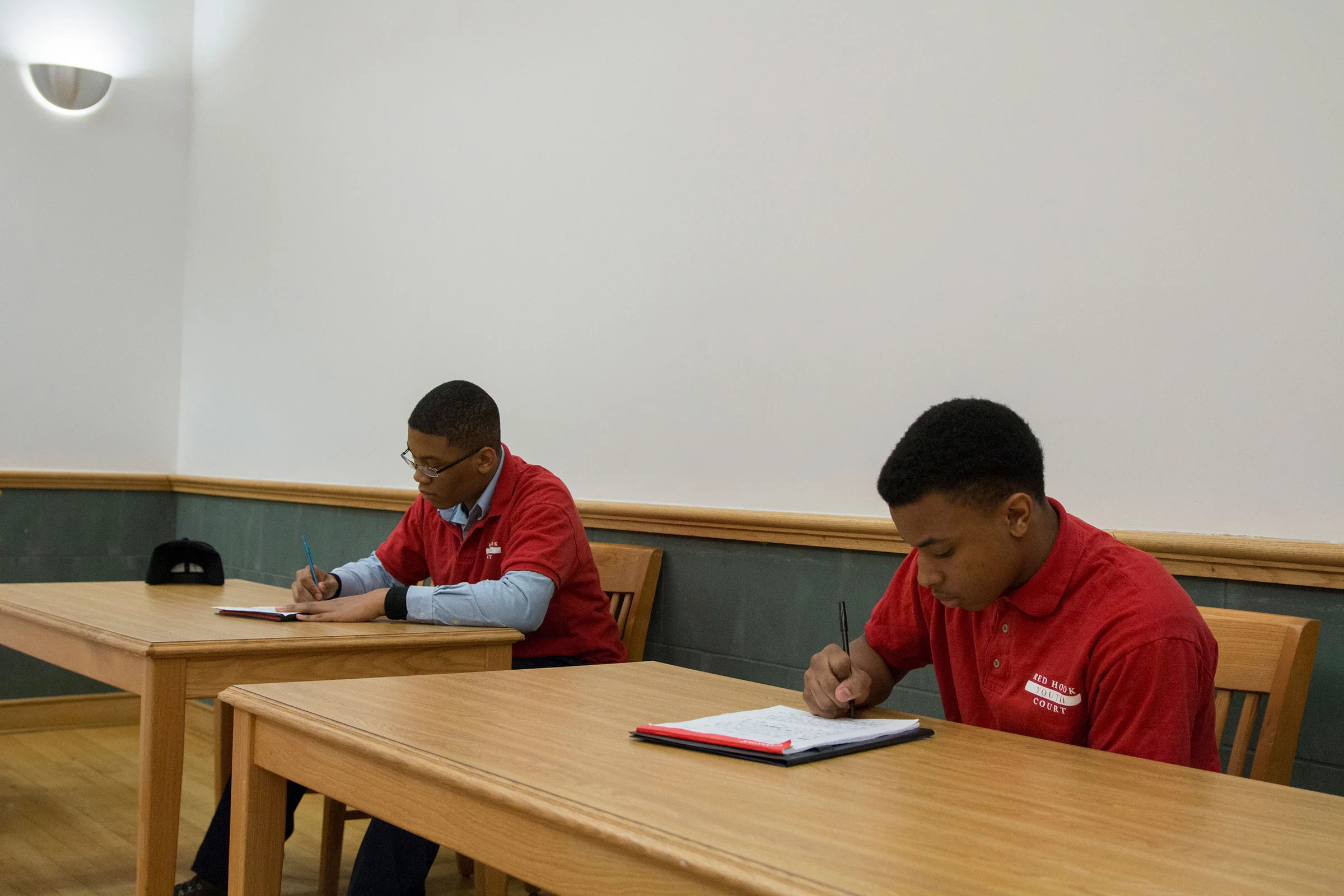  Demetri, 16, (right) acts as Community Advocate while Dejon, 15, (left) acts as Youth Advocate. The Youth Advocate interviews the respondent and preps them for questions from the jury, as well as delivering a statement of defense. “I like to help pe