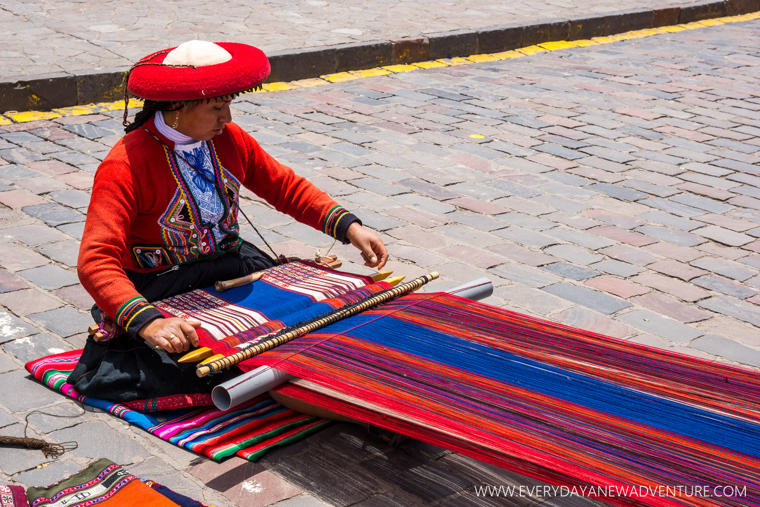 One of the many skilled weavers working in the main square.