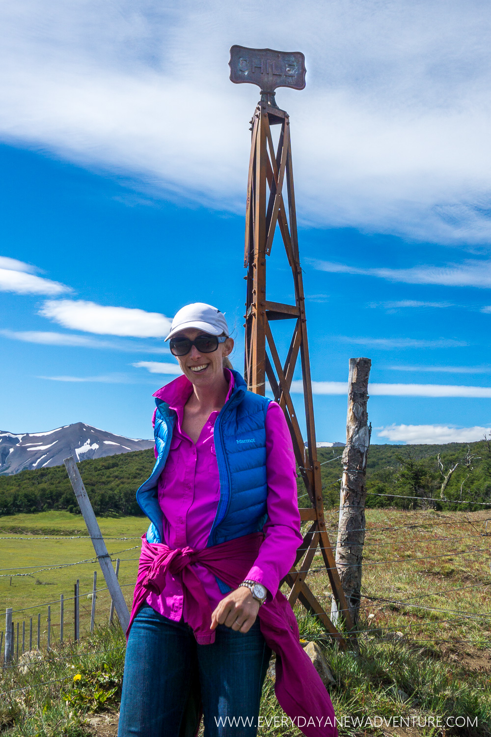The sign post behind me is the border marker. One side says Chile, the other Argentina. That fence is the border between the two countries.
