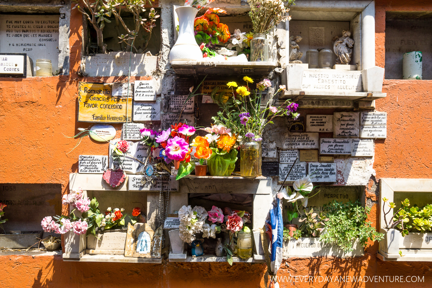 Plaques of gratitude around the grave of the local saint.