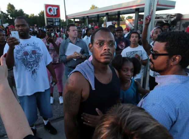 Ferguson-protesters-stand-up-for-child.jpg