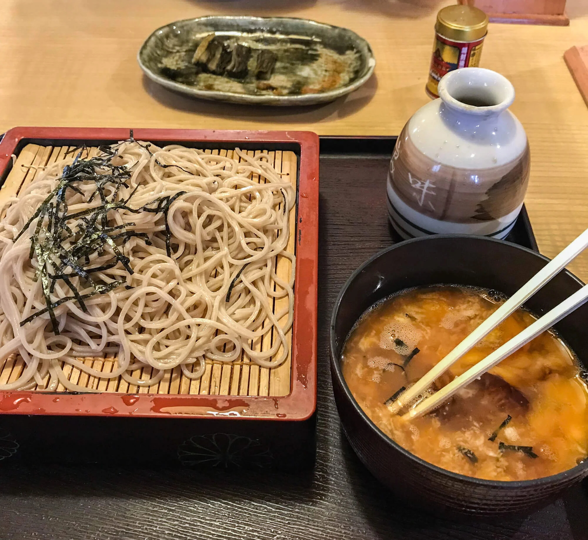 A TYPICAL LUNCHTIME MEAL - SOBA NOODLES, WITH SOME FAMOUS NOZAWANA IN THE BACKGROUND