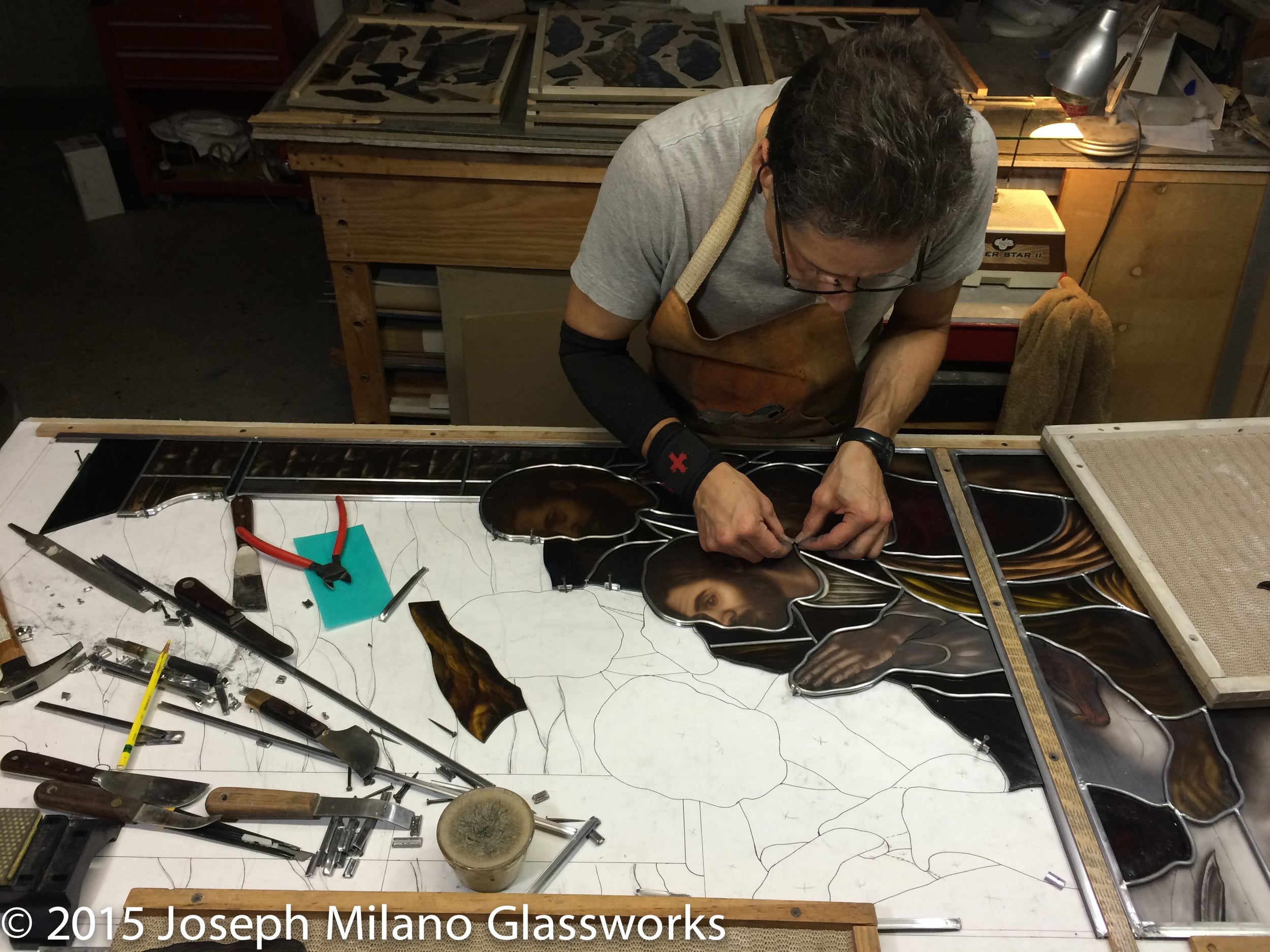 Glazing the upper panel of the third lancet in the Last Supper stained glass window.