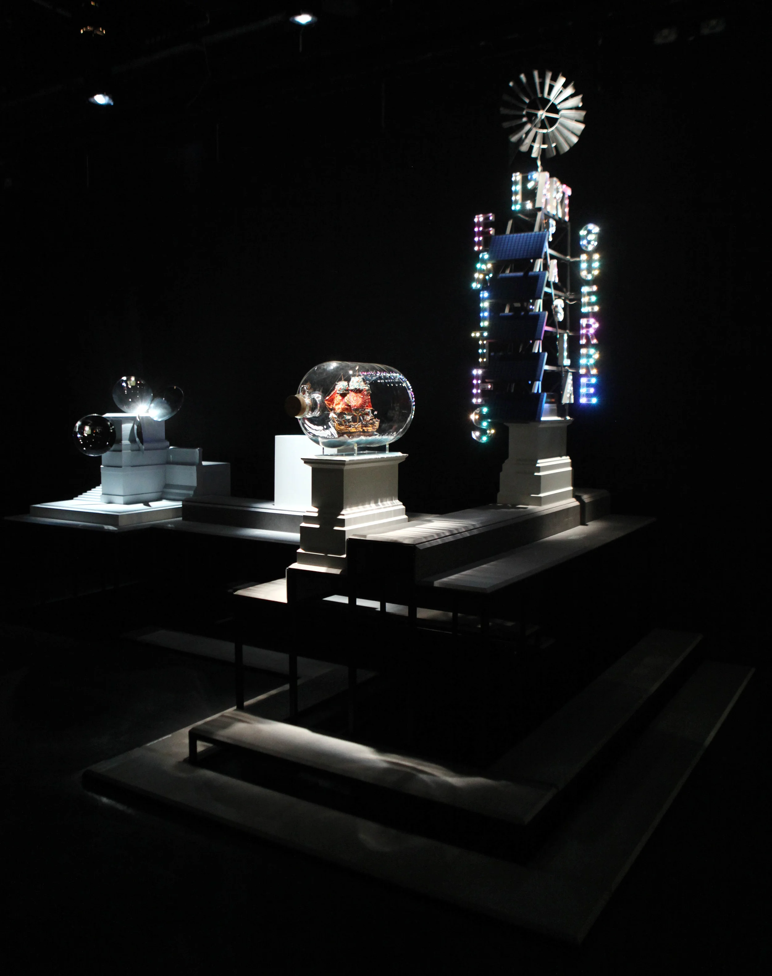 Fourth Plinth: Contemporary Monument, installation view, ICA, London, 2012. Left: Anish Kapoor, Sky Plinth, 2007 Centre: Yinka Shonibare, MBE, Nelson’s Ship in a Bottle (Maquette for fourth plinth proposal 2007), 2007 Right: Bob and Roberta Smith, Faîtes l’Art, pas la Guerre (Make Art, Not War), 2006.